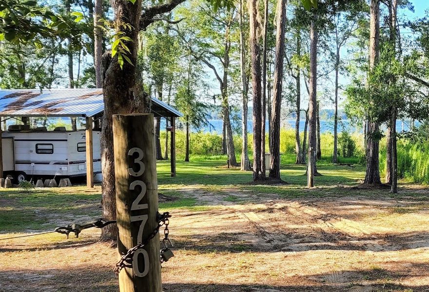 Looking for a waterfront weekend getaway spot or a gorgeous homesite on the lake? This is it! This beautiful lakefront property is already equipped with a pole barn, camper, porch, gate, septic, newer well, and two 30 amp hookups. You'll love the wildlife, kayaking, and great bass fishing. Plus there is a nearby ramp for boats. The sunrise view will take your breath away. Located about 45 minutes from Panama City Beach and ECP airport - it's the perfect weekend escape. Or, build a house or mobile home and call it home all year long.