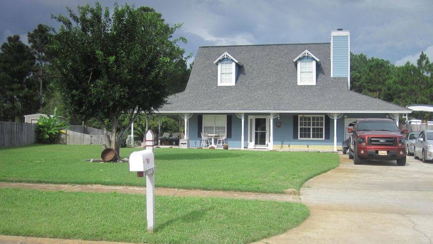 WOW! What a home! Wrap-around porch situated on an enormous lot. Two story with two bedrooms upstairs and two downstairs. Open concept with large great room featuring 55'' LCD flat screen mounted on the wall with Blue Ray Surround Sound included. Kitchen features granite tiled counter tops, tiled backsplash, refrigerator with ice/water in door, electric oven/stove, built in microwave, and a window with a view to the back yard. An additional office/gym with a doggie door leading to the fenced back yard and a smaller fenced doggie area. Upstairs master bedroom with walk-in closet and extra closet. Master bath with dual vessel vanities and oak soft-close doors and cabinets. Walk-in shower features dual shower heads, with separate temperature controls. Hot tub out back with one shed for the riding lawnmower (for sale) and a workman's workshop with electricity, windows, and lots of cabinetry.  Back yard backs up to the reservation for lots of privacy.  There are too many features to list here.  Come see this immaculate home before it's too late. And Seller is offering a one-year pre-paid Home Warranty for buyers' peace of mind.