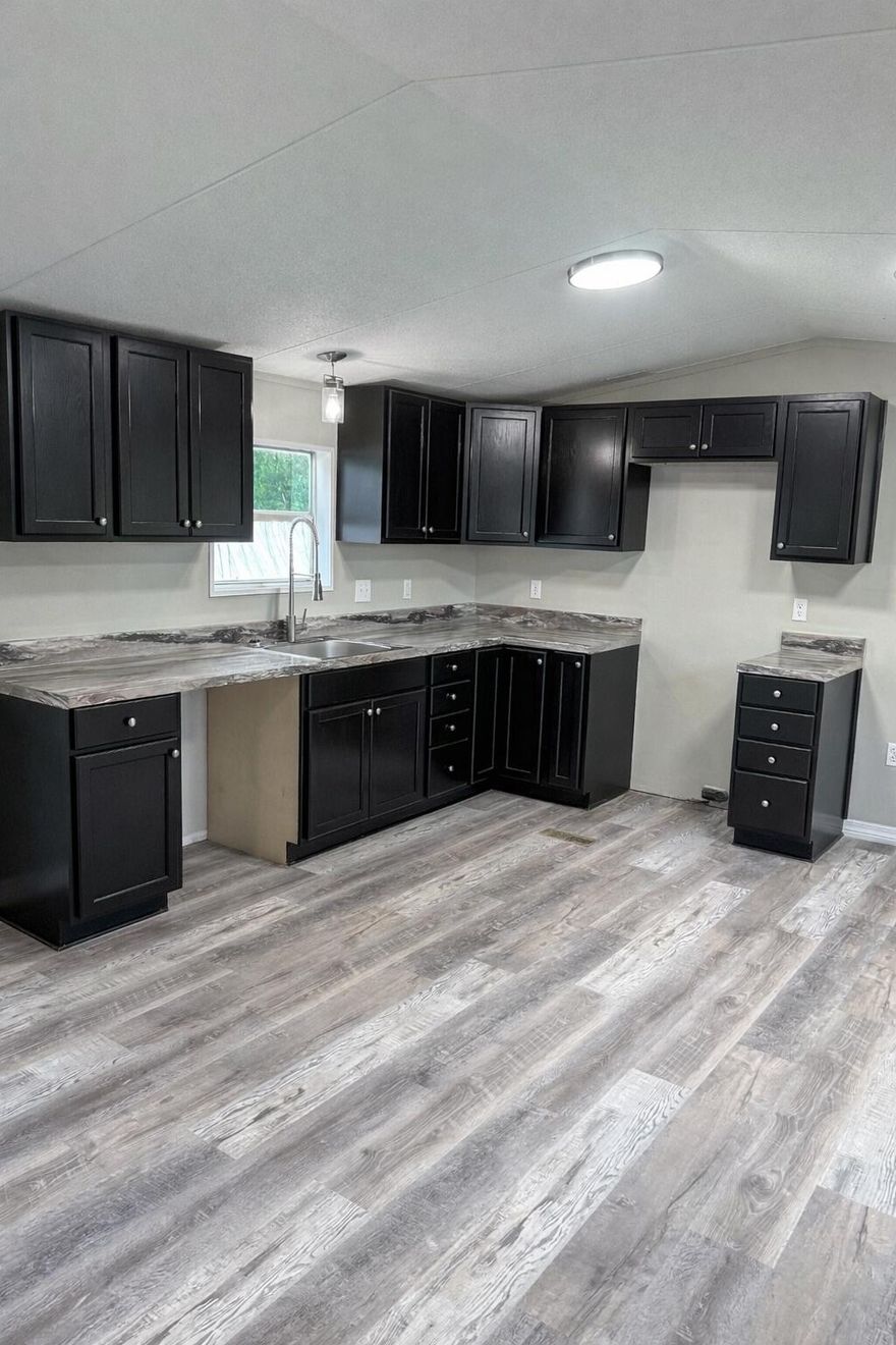 Beautifully renovated 3-bedroom, 2-bath manufactured home in Holt, FL. This move-in-ready home features an open-concept living, dining, and kitchen area with updated flooring throughout and a bright, modern feel. The kitchen offers new cabinetry, ample counter space, and flows seamlessly into the main living area. The split bedroom layout provides privacy, with a spacious primary suite featuring an ensuite bath, while two additional bedrooms share a full guest bathroom. Both bathrooms have been refreshed with clean finishes and modern fixtures. Neutral paint tones, updated lighting, and new flooring give the home a fresh, cohesive look throughout. Situated on a quiet street, this property offers affordable living with modern updates in a convenient location. Ideal for first-time buyers, downsizers, or investors looking for a turnkey opportunity.