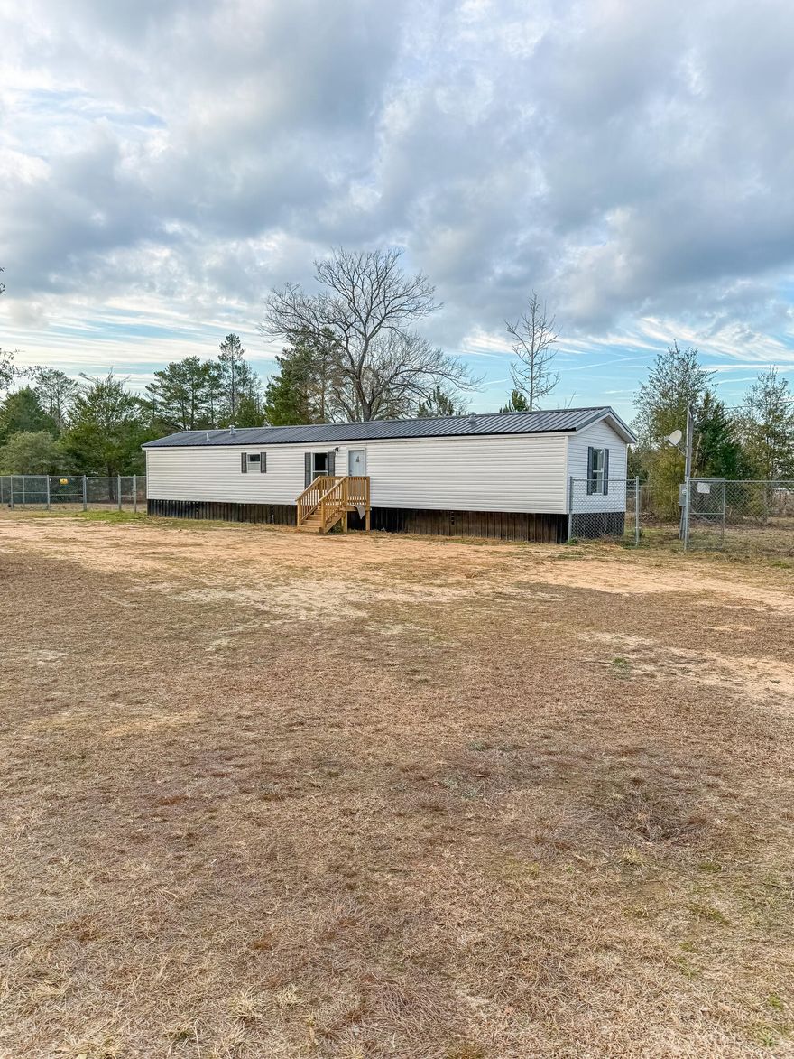 Beautifully renovated 3-bedroom, 2-bath manufactured home in Holt, FL. This move-in-ready home features an open-concept living, dining, and kitchen area with updated flooring throughout and a bright, modern feel. The kitchen offers new cabinetry, ample counter space, and flows seamlessly into the main living area. The split bedroom layout provides privacy, with a spacious primary suite featuring an ensuite bath, while two additional bedrooms share a full guest bathroom. Both bathrooms have been refreshed with clean finishes and modern fixtures. Neutral paint tones, updated lighting, and new flooring give the home a fresh, cohesive look throughout. Situated on a quiet street, this property offers affordable living with modern updates in a convenient location. Ideal for first-time buyers, downsizers, or investors looking for a turnkey opportunity.