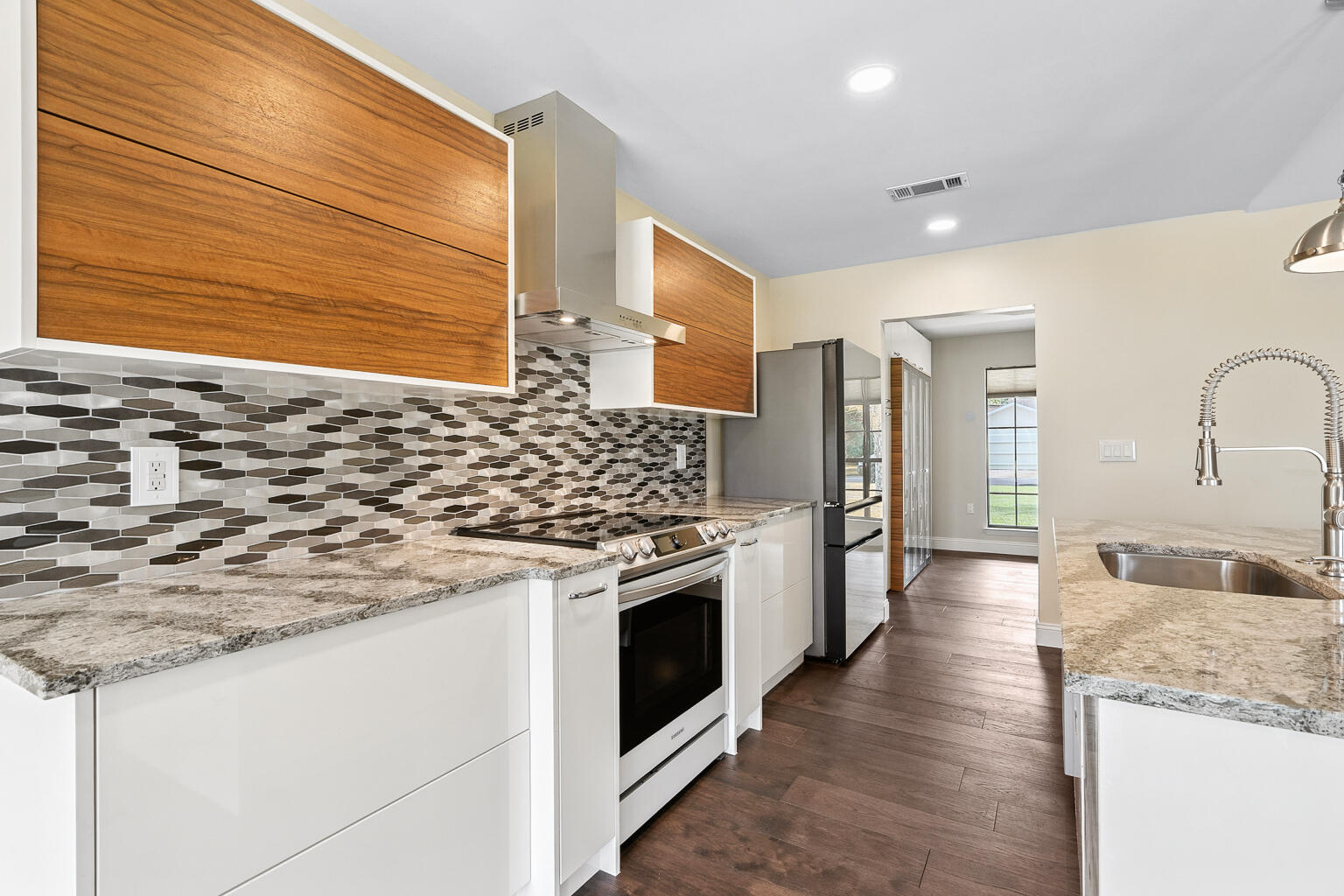Luxurious Fully Renovated Brick Home! Welcome to 30 Ashford Court--a beautifully reimagined single-story all-brick home set on an oversized corner lot just 4 miles from Hurlburt Field and 5.3 miles from Okaloosa Island. This move-in-ready property combines modern elegance with timeless comfort, offering thoughtful design and top-quality finishes throughout. Originally purchased with the vision of being a personal residence, this home underwent over three years of careful, intentional renovation. Every detail--from the flooring to the cabinetry--was chosen for quality, comfort, and longevity. In the end, plans changed, and the decision was made to offer this exceptional property for sale instead. Step inside to a spacious open-concept floor plan featuring cathedral ceilings, bright LED lighting, and stunning waterproof Hickory hardwood flooring. The inviting living area centers around a cozy wood-burning fireplace, perfect for relaxing or gathering. Highlights of this Exquisite Home: Showroom Kitchen: Designed by Santa Rosa Kitchen & Bath, this brand-new gourmet kitchen boasts electro-automatic cabinetry, glass-front Samsung appliances, a large island with premium Cambria stone countertops, and a custom lighted pantry/bar/storage area. Spa-Inspired Master Suite: The primary bath features a walk-in shower, skylight for natural light, freestanding soaking tub, and dual vanities, complemented by a spacious walk-in closet. Elegant Bathrooms: Fully renovated with modern finishes for both style and function. Garage & Storage: Oversized two-car garage with dual new belt-driven openers, ideal for parking and workshop space. Garage features plenty of storage as well as a new epoxy coated floor. Outdoor Living: Privacy-fenced oversized lot with ample room for a pool, boat, or camper. Just 0.2 miles from Elliott Park with playgrounds, tennis courts, and pavilions. Additional Features: Whole-house blinds, custom lighting, and a seamless blend of functionality and design throughout. No HOA restrictions provide added flexibility for future plans. With every detail thoughtfully upgraded over years of planning and craftsmanship, this property offers the perfect balance of luxury, comfort, and practicality. *Please note: Some photos have been virtually staged*