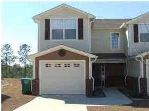This well kept developed town home community consist of a nature preservation area with nature trails, a gazebo and overlook pavillion. Cool down after a long day at work by the community pool with changing rooms. This location south of I-10 makes for a very convenient drive to area beaches and military bases. This is a two story traditional design with brick and Hardy plank exterior. The floor plan has the living, kitchen, and half bath downstairs, and bedrooms with baths upstairs.