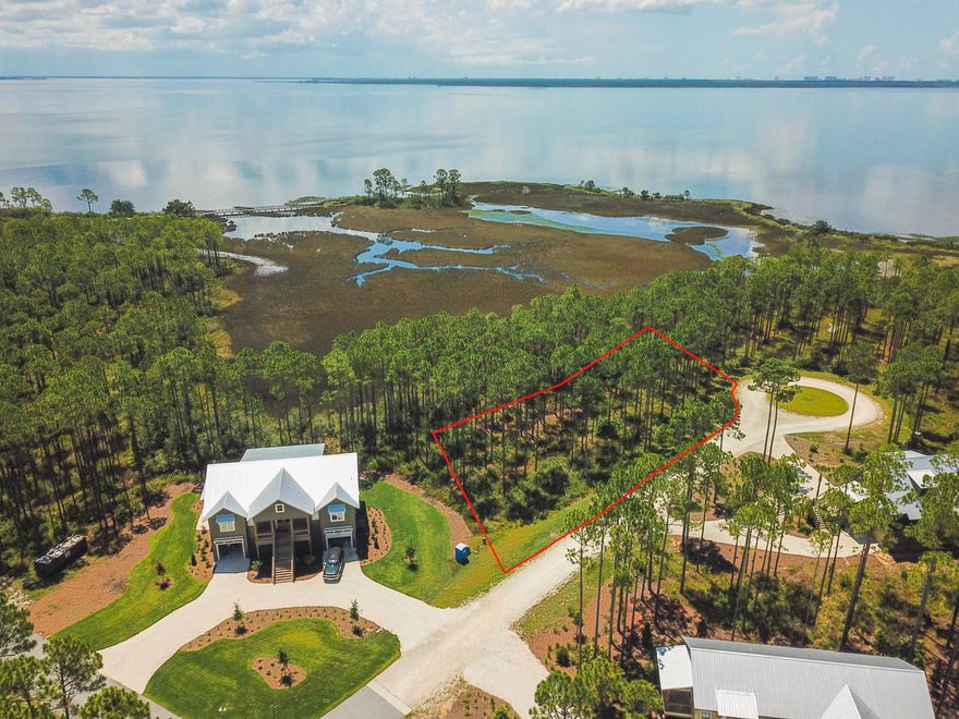 This is a prime lot that overlooks the tidal marsh located in RiverCamps, an exclusive St. Joe waterfront community, just 10 minutes from the beach and housing fewer than 450 homes! RiverCamps on Crooked Creek is a 1,500 acre pine forest gated community surrounded by three spectacular bodies of water, Crooked Creek, West and the Intracoastal Waterway. The amenities in this community include a 25,000 sq.ft. RiverHouse, the community activity center, encompassing of decks, boardwalks, covered pavilions, and a 600 foot pier that extends into West Bay. The RiverHouse also includes a pool, hot tub, fitness center, library, catering kitchen, dining area and our homeowners can reserve kayaks, canoes and bikes. The community boasts an upscale boat basin with a private boat ramp.