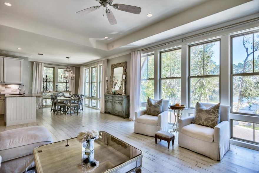 Immaculate custom-built home with 3 bedrooms, 3 Baths, PLUS an office located in the private, small and beautiful waterfront community of Sacred Oaks. Home features custom finishes throughout, including lighting, vanities, and automatic, timed blinds throughout home. Located off Mack Bayou with gorgeous wide swath water views one tier off. White pine hand scrubbed floors, cool and quaint walled private backyard with a heated pool and all new pool equipment. Just around the corner from everything you need...Sacred Heart Hospital and Grand Boulevard with movie theater, restaurants, shopping, Publix and more. Low HOA fees. A dock on the water is provided for all residents to use with their boat. Mother-in-law suite w/ kitchen. This is a must see unique and beautiful property!