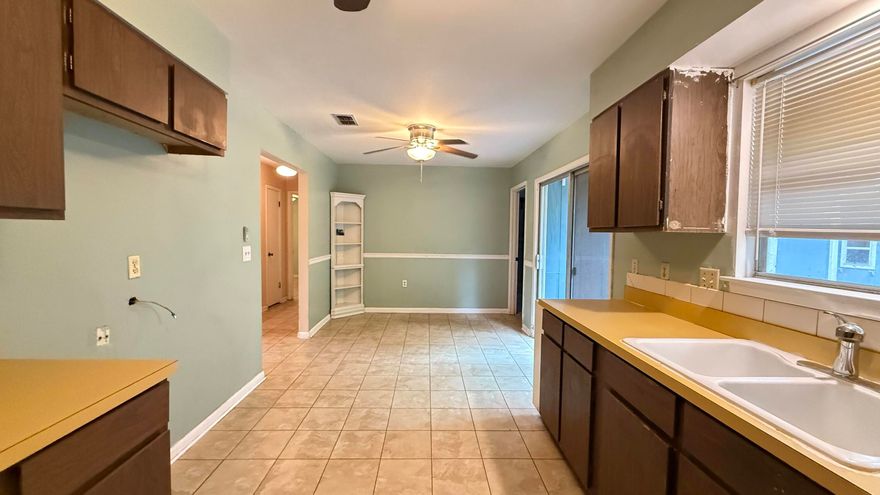 Perfectly located, this charming 3-bedroom, 2-bath home offers 1,362 sq. ft. of opportunity! Property is ready for your personal touch. Featuring a metal roof (2008), Hot water heater (2005) a brick front façade with freshly repaired/painted T-111 wood siding, covered front porch perfect for relaxing. The open back deck and yard building offer additional space for outdoor enjoyment. Inside, you'll find a cozy living room, eat-in kitchen, and a bonus room/Flex space. The hall bathroom includes a tub-shower combo, while the primary bedroom features a barn door and a walk-in shower. This home is priced to reflect its potential. Seller offering a $500 Home Warranty  Don't miss this chance to create your dream space—schedule your showing  Today!