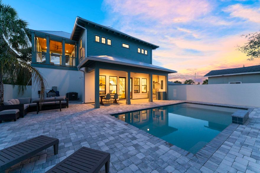 Welcome to your turnkey coastal haven! Step inside and immerse yourself in the fusion of modernity and timeless elegance. The living room features a captivating coffered ceiling and a sleek electric fireplace, perfect for gatherings or relaxation. The designer kitchen dazzles with quartz countertops, stylish cabinets, and a striking marble backsplash. The split floor plan provides two primary suites, ensuring privacy and comfort for all occupants.Enjoy the oversized veranda, outdoor kitchen, and saltwater pool in your private oasis. Just moments from beach access #94, it's an ideal investment for short-term rentals or your dream vacation spot. Experience the perfect blend of modern craftsmanship, coastal allure, and effortless luxury at 322 Sea Breeze Drive.