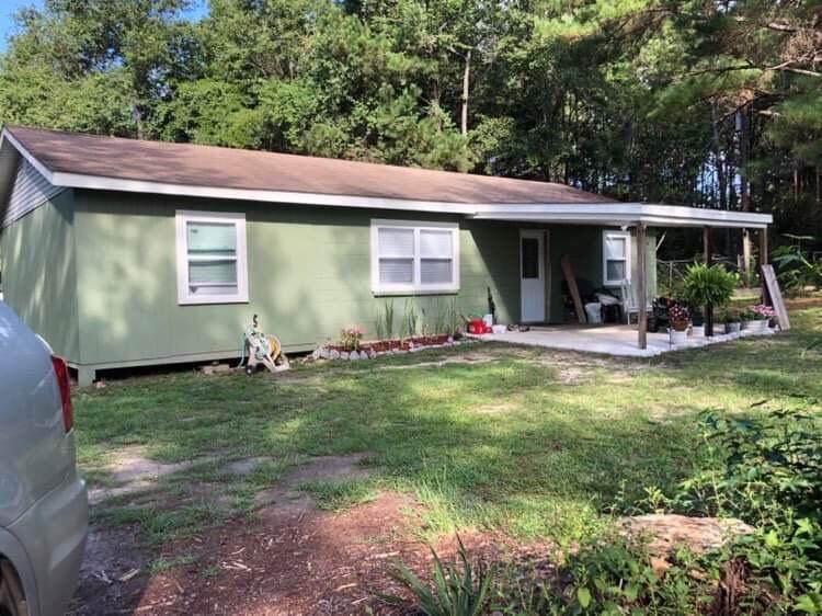 This property is a must see! 10.5 acres, partially cleared with an adorable cottage style home. New plumbing and duct work throughout. Well pump is new. The layout of the home is very practical. Two decent size bedrooms and a large bonus room that could easily be converted to a third bedroom. 1400 Feet of Highway frontage with the home nestled securely back into the pines.  Peaceful view overlooking pasture land, sunsets are in full view and jewel toned. This is country living with the best of everything in reach! One mile from the nearest gas station/convenience store, 15 minutes from the famous Ponce De Leon Springs and Vortex Springs. 50 minutes to our white sand beaches! Bus stops directly at property for our B+ rated school system. Neighborhood is charming & brimming with local pride.