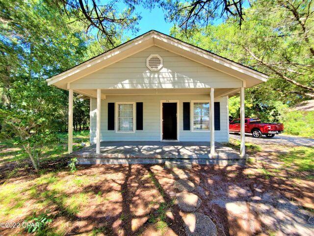 Enjoy this old-style Florida home nestled in the middle of a fully fenced large lot with lots of shade trees and a natural wooded view from your covered back porch. The house needs some TLC, but the two covered porches make the home feel larger than the square footage and was built with yellow pine wood and has been upgraded with hardy board siding. The plumbing and electrical are in good condition, and the water heater is only three years old. With some TLC, this property would be a great place to call home or fetch you a great rental income. The property allows for short-term rentals, allowing for a vacation home business. With a location like this, you could always tear down the existing home, start over, and build your dream home with a fantastic resale value.