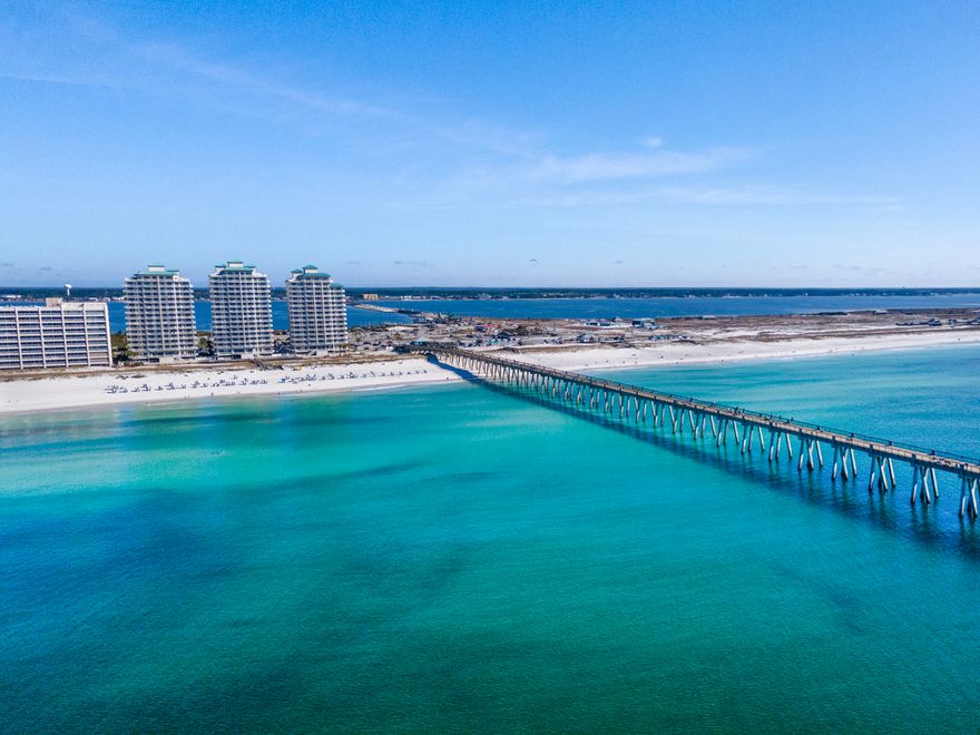 Experience the height of coastal luxury with this 16th floor penthouse unit at the Gulf-front Summerwind Resort on Navarre Beach! As a top floor residence, this unit offers unparalleled, panoramic views of the Emerald waters of Navarre Beach. Complete with an expansive, wrap-around rooftop balcony that is a true extension of your living space for catching the most amazing sunrise/sunset views while relaxing or dining al fresco. Inside, you'll discover high ceilings with a classic crown molding for an elegant touch. Featuring a split floor plan with 2 bedrooms, 2 full bathrooms, and a bunk room. The updated kitchen looks out over the breakfast bar to the dining room and living area - all with a breathtaking view of the water through the floor to ceiling windows and slider door. The primary suite is just off of the living room. Featuring its own access to the wrap around balcony, oversized closet, and full ensuite bathroom. This unit also includes its own deeded parking space. Plus, enjoy all of the amenities Summerwind Resort has to offer - including 3 pools - 1 of which is heated, hot tubs, BBQ grills, private beach access, Beach chair service, exercise room, and more! All while being one of the closest buildings to the Navarre Beach Fishing Pier. Everything "Navarre Beach" is practically at your doorstep!