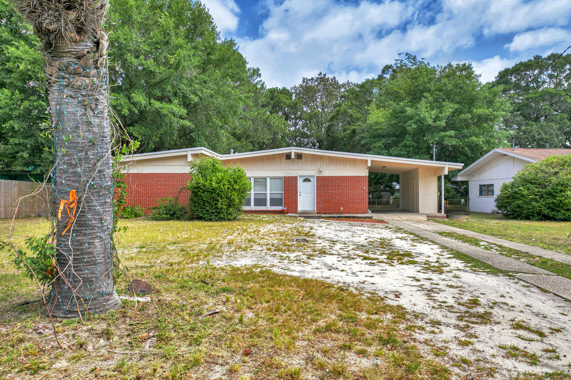 Welcome to Ferry Park! This gorgeous 3 Bedroom - 2 bath home features many highlights your family and friends will enjoy for a lifetime! A gorgeous LARGE brick fireplace, Terrazzo floors, raised vaulted ceilings and bay windows! The open living concept is perfect for entertaining and family time. Gather around the fireplace hours. A RARE oversized backyard w/ plenty of room for BBQ, family time football, parties and more! Conveniently located just minutes from BOTH military bases, the Emerald Coast beaches and downtown shopping/restaurants. The carport features 3 storage areas to keep your prized possession in. The Master bedroom is perfect for relaxing after a long work day. Home also features an Indoor laundry room. The home in the PERFECT location has arrived! Act Fast!