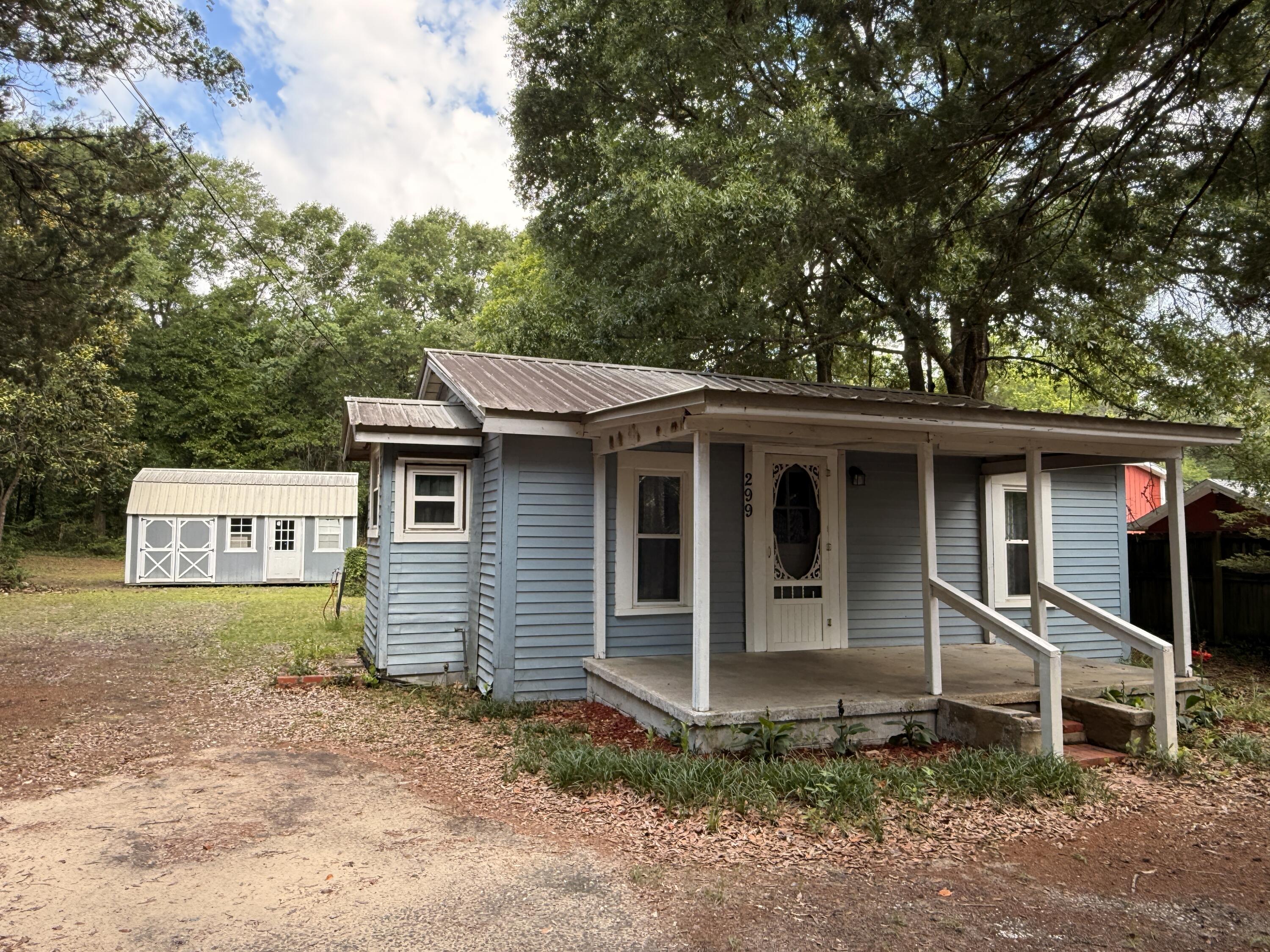 Sellers are now offering owner financing with 10% down, Minimum 700 FICO - call for details! Discover the perfect blend of charm, privacy and potential in this 2-bedroom, 1-bathroom Tiny House/Cottage with Bonus/Office! Located in central Crestview on a spacious .47-acre lot just two homes away from Twin Hills Park - So close that you can see the Park Lake from the front yard! Conveniently close to schools, restaurants and shopping! Updates include a complete rewire w/all new plugs & switches, energy-efficient mini-split HVAC systems, updated vinyl windows, newer appliances, vinyl siding, and a durable metal roof. The warm front porch invites you into a cozy living room with a charming nook, while the kitchen offers ample oak cabinets, large refrigerator/freezer w/icemaker, Microwave, countertop dishwasher and an electric range. The oversized bathroom boasts a full tub/shower and laundry space, while the bedrooms and bonus room are ready for your personal touch. Outside, enjoy a HUGE serene backyard with mature trees, a 12x20 storage shed and ample parking on an adjacent dead-end road that meets the railroad track. This home is completely functional/livable with endless potential for updates to create your dream retreat! Twin Hills Park has a walking path, playground & basketball court. Enjoy the numerous ducks and turtles as you walk the bridges. Home is Sold AS-IS. Cash or rehab loans only. Schedule your showing today!