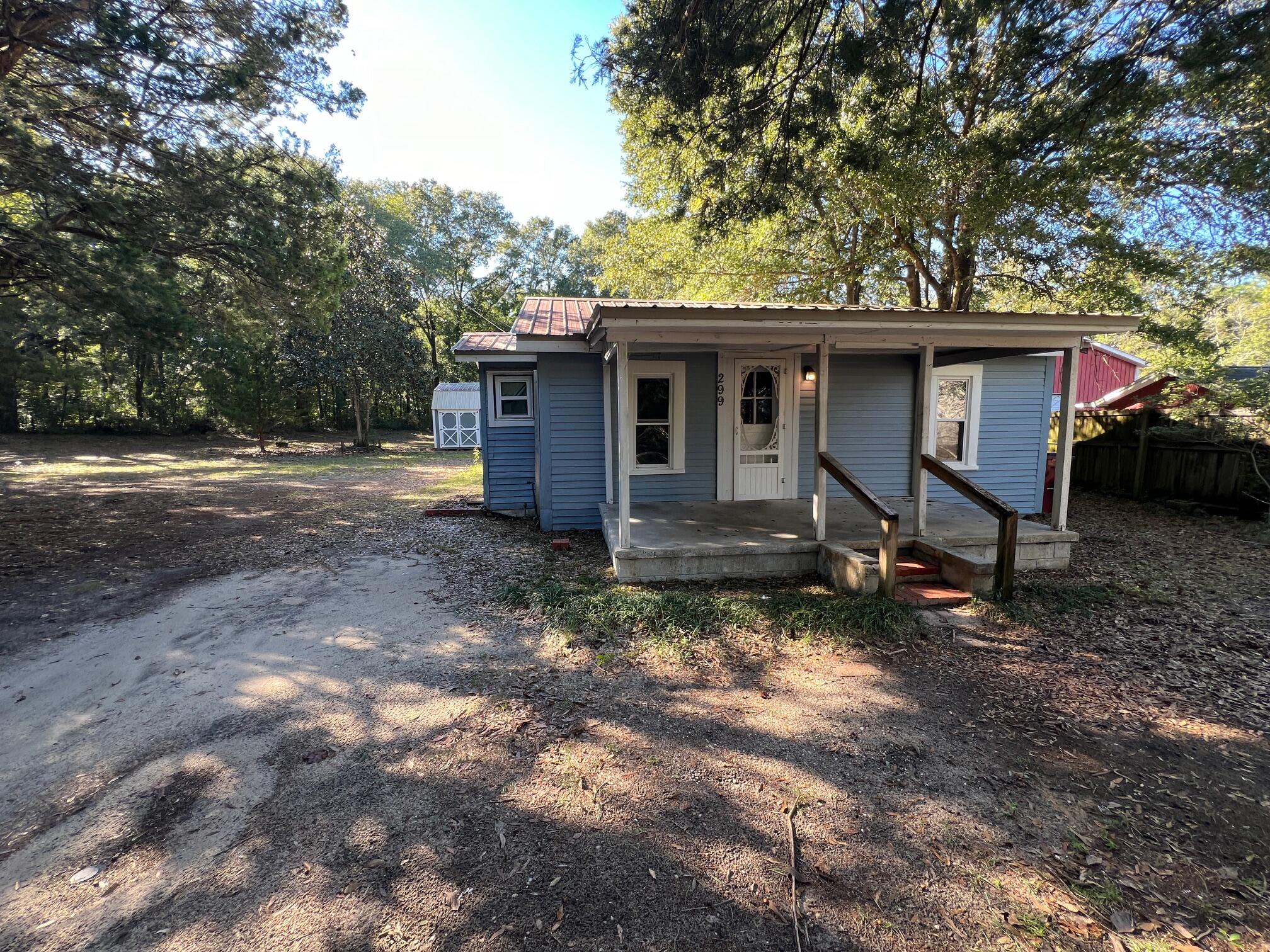 Discover the perfect blend of charm, privacy and potential in this 2-bedroom, 1-bathroom Tiny House/Cottage with Bonus/Office!  Located in central Crestview on a spacious .47-acre lot just two homes away from Twin Hills Park - So close that you can see the Park Lake from the front yard! Conveniently close to schools, restaurants and shopping!  Updates include a complete rewire w/all new plugs & switches, energy-efficient mini-split HVAC systems, updated vinyl windows, newer appliances, vinyl siding, and a durable metal roof. The warm front porch invites you into a cozy living room with a charming nook, while the kitchen offers ample oak cabinets, large refrigerator/freezer w/icemaker, Microwave, countertop dishwasher and an electric range. The oversized bathroom boasts a full tub/shower and laundry space, while the bedrooms and bonus room are ready for your personal touch. Outside, enjoy a HUGE serene backyard with mature trees, a 12x20 storage shed and ample parking on an adjacent dead-end road that meets the railroad track.  This home is completely functional/livable with endless potential for updates to create your dream retreat! Twin Hills Park has a walking path, playground & basketball court. Enjoy the numerous ducks and turtles as you walk the bridges. Home is Sold AS-IS. Cash or rehab loans only.  Schedule your showing today!