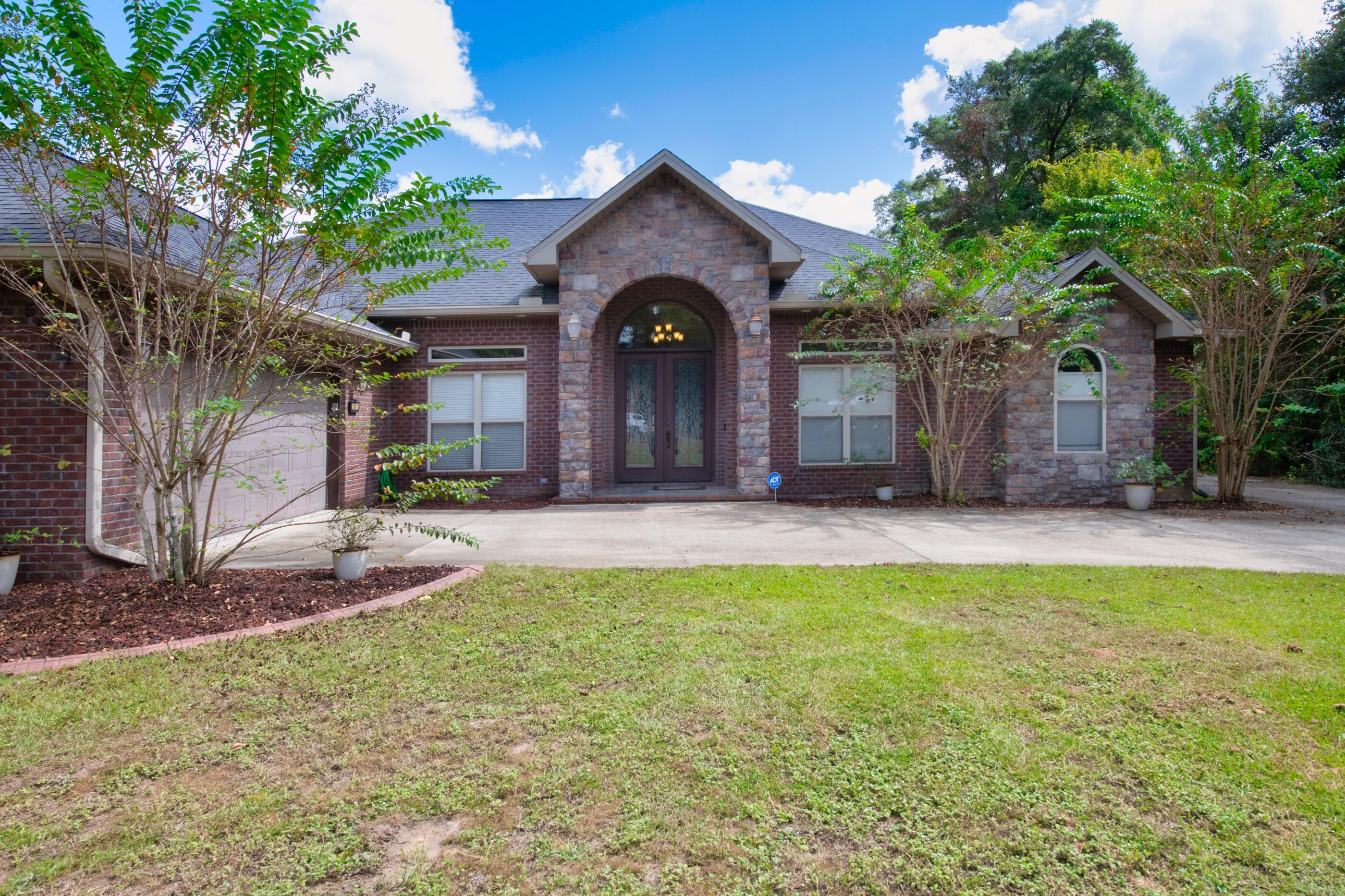 Accepting backup offers. Contract in place. Step into this beautiful custom-built home with 4 bedrooms and 2 1/2 bathrooms situated on over 11 acres. The grand front doors open into the foyer and a view of the dining room. Living room has beautiful coffered ceiling and engineered hardwood floors throughout all living areas. Bathrooms and laundry area have tiled floors. Open the French doors from the living room to the covered patio, summer kitchen and enclosed pool. Pool is heated with solar panels. Summer kitchen has grill, sink and refrigerator, great for entertaining. Home also has a privacy fenced back yard. The kitchen has stainless steel appliances which include gas range with double ovens, microwave, dishwasher and refrigerator with ice maker. Quartz