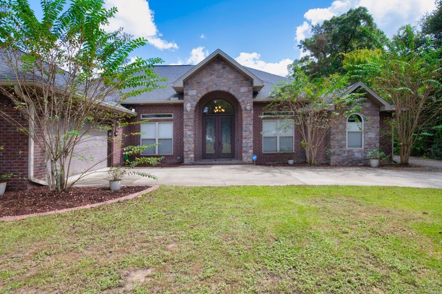 Accepting backup offers. Contract in place. Step into this beautiful custom-built home with 4 bedrooms and 2 1/2 bathrooms situated on over 11 acres.  The grand front doors open into the foyer and a view of the dining room. Living room has beautiful coffered ceiling and engineered hardwood floors throughout all living areas.  Bathrooms and laundry area have tiled floors. Open the French doors from the living room to the covered patio, summer kitchen and enclosed pool. Pool is heated with solar panels. Summer kitchen has grill, sink and refrigerator, great for entertaining.  Home also has a privacy fenced back yard.  The kitchen has stainless steel appliances which include gas range with double ovens, microwave, dishwasher and refrigerator with ice maker. Quartz