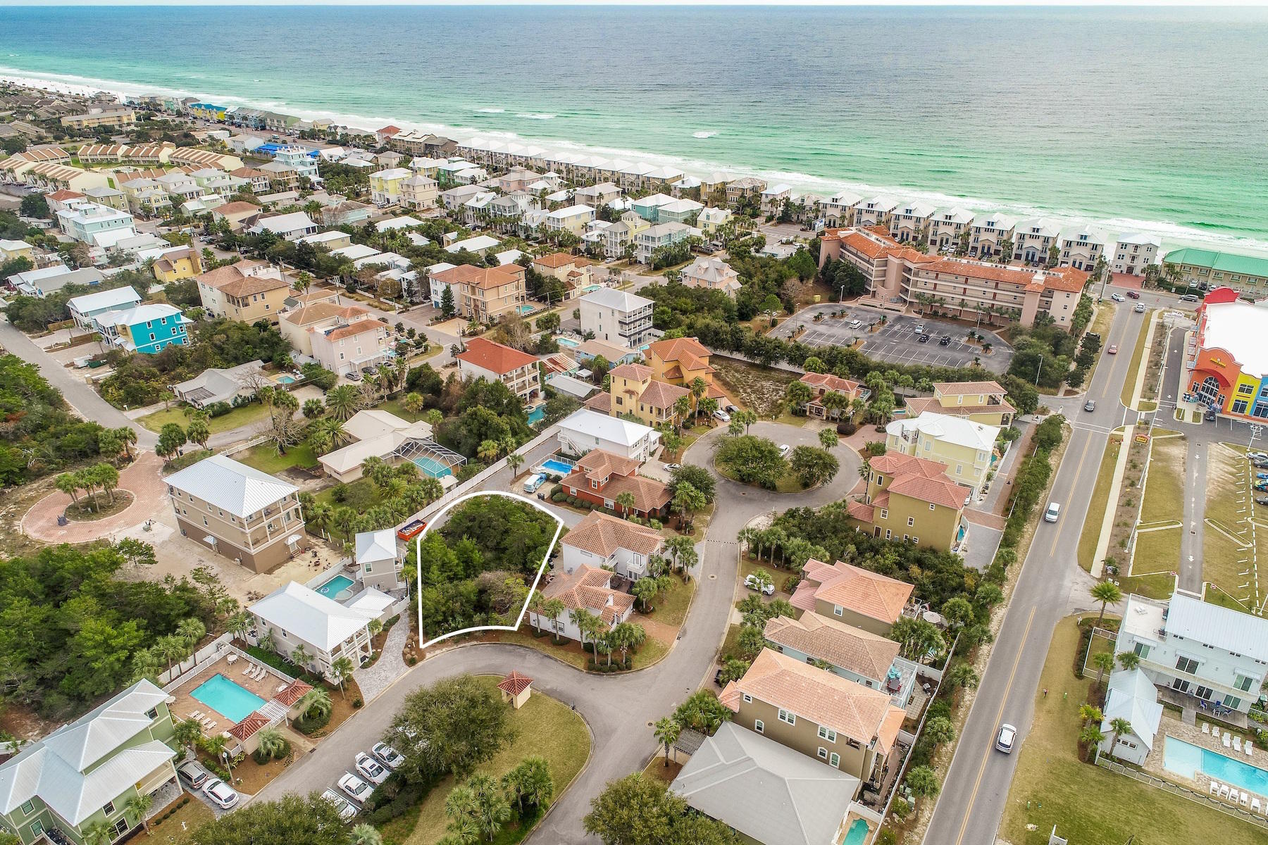 Extraordinary opportunity to build on one of the largest lots remaining in the desirable gated community of Emerald Waters Village in Miramar Beach. Lot 61 St. Nicholas Court is just two lots from the southern community pool and very close to the neighborhood's walkway to gated, deeded beach access. This lot features alley access allowing for rear garage entry in addition to a common area and overflow parking across the street. This lot is approved for two structures allowing a detached garage with potential carriage house above, plus room for a private pool. Neighborhood entrance/exit onto Holiday Road provides easy access to both Highway 98 and Scenic Gulf Drive. Water tap fees have already been paid and a survey is available upon request.