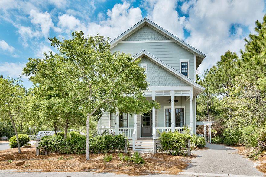 From its outstanding corner location in one of WaterColor's most popular areas, backing up to a heavily treed neighborhood conservation area, this immediately endearing home overlooks a tranquil pond. Open concept living and dining room areas enjoy dramatic 14 foot tall ceilings that carry throughout the remainder of the first floor. Gleaming hardwood floors contrast with tall white baseboards, simply elegant crown molding, as well as white raised panel cabinets in the adjoining kitchen.