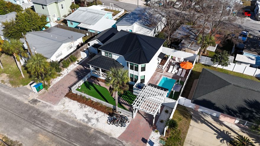 EXCEPTIONAL IN EVERY WAY! Opportunities like this are exceedingly rare -- a fully reimagined dual-residence coastal compound just three blocks from the Gulf, masterfully renovated to the highest of standards. The impressive 2,000+ square foot main home and private detached guest cottage (ADU) have been curated with designer-level finishes, sophisticated details, and impeccable craftsmanship throughout. Anchoring the property is a brand-new private in-ground saltwater pool, creating a true resort-caliber oasis that elevates both everyday living and upscale entertaining. Whether envisioned as a refined personal retreat, a multigenerational sanctuary, or a high-performing income-producing investment, this turnkey property delivers an extraordinary combination of luxury, flexibility, and long- term value rarely found in this coveted coastal setting.

The main residence with 4 bedrooms and 3.5 baths, welcomes you with an expansive open-concept living area centered around a gas fireplace and a showpiece kitchen featuring a gas, dual fuel chef's stove with convection oven, an oversized breakfast bar, abundant workspace, and seamless flow into the dining area with custom built-in seating. A private first-floor primary suite offers a spa-inspired bath, while a convenient laundry room and powder bath complete the main level. Upstairs, you'll find a second luxurious primary suite with a breathtaking bathroom featuring a soaking tub and generous tiled shower, along with an additional guest bedroom, full bath, and a custom bunk room with two built-in bunk sets--perfect for maximizing rental potential or hosting guests. Maintenance-free luxury vinyl plank flooring runs throughout the living areas, with tile in all baths for a clean, modern finish.

Outdoor living rivals that of a private resort. Enjoy the inground swimming pool, gas firepit with Adirondack seating, expansive back deck, and a fully outfitted entertainment area with large-screen TV. The professionally designed grounds include landscape lighting, hardscaping, charming fencing, a paver driveway, and a pergola-style carport.

Adding tremendous flexibility and value, the detached guest cottage features its own private driveway and entrance, allowing it to function as a completely separate rental or private residence. This studio-style retreat includes a stylish kitchen, living/sleeping space, and a beautifully appointed bathroom--ideal for guests or additional income.

Currently operating as a successful short-term rental with strong income history despite limited rental time, this turnkey property offers exceptional versatility--live in one residence and rent the other, or maximize returns by renting both. Connected to city sewer (a major advantage) and located in the highly desirable Laguna Beach area near 30A, this property delivers the look, feel, and quality of a premier coastal luxury home.

A true coastal compound combining lifestyle, location, and income potential--properties of this caliber rarely become available.  Call your favorite realtor and make an appointment to see it today!