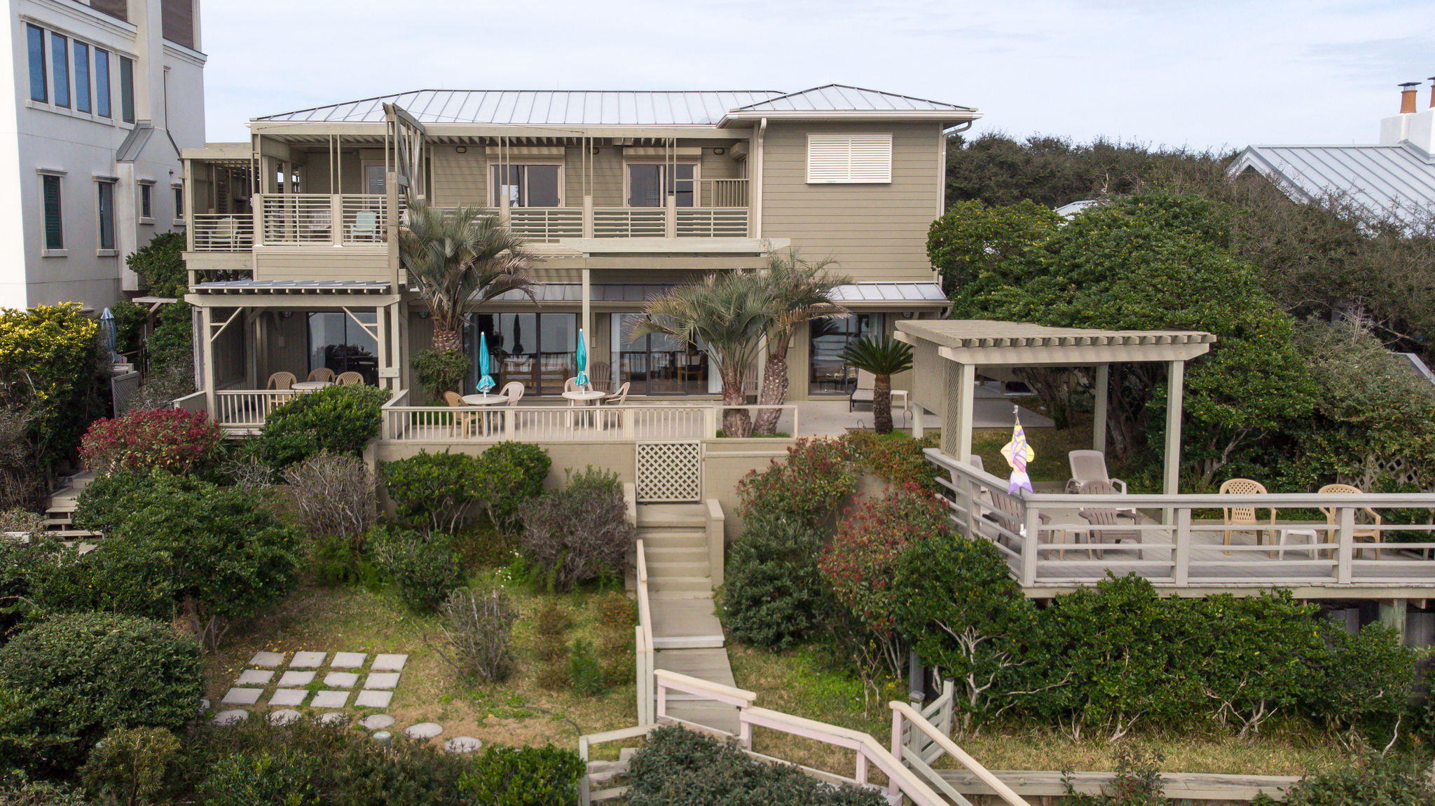 Welcome to an Old Florida Paradise. This stunning 1/2 acre beach property is one of a kind, boasting 87' of beach frontage and a 38' elevation. For protection from storms,there is a marine grade seawall plus a interlocking armory wall. Native trees and plants add to the pristine landscape to give you peace and privacy. The decks have been designed for ultimate privacy while capturing sunset and sunrise views. The original home block construction was kept and new additions thoughtfully added to make this a perfect beach home or rental unit.