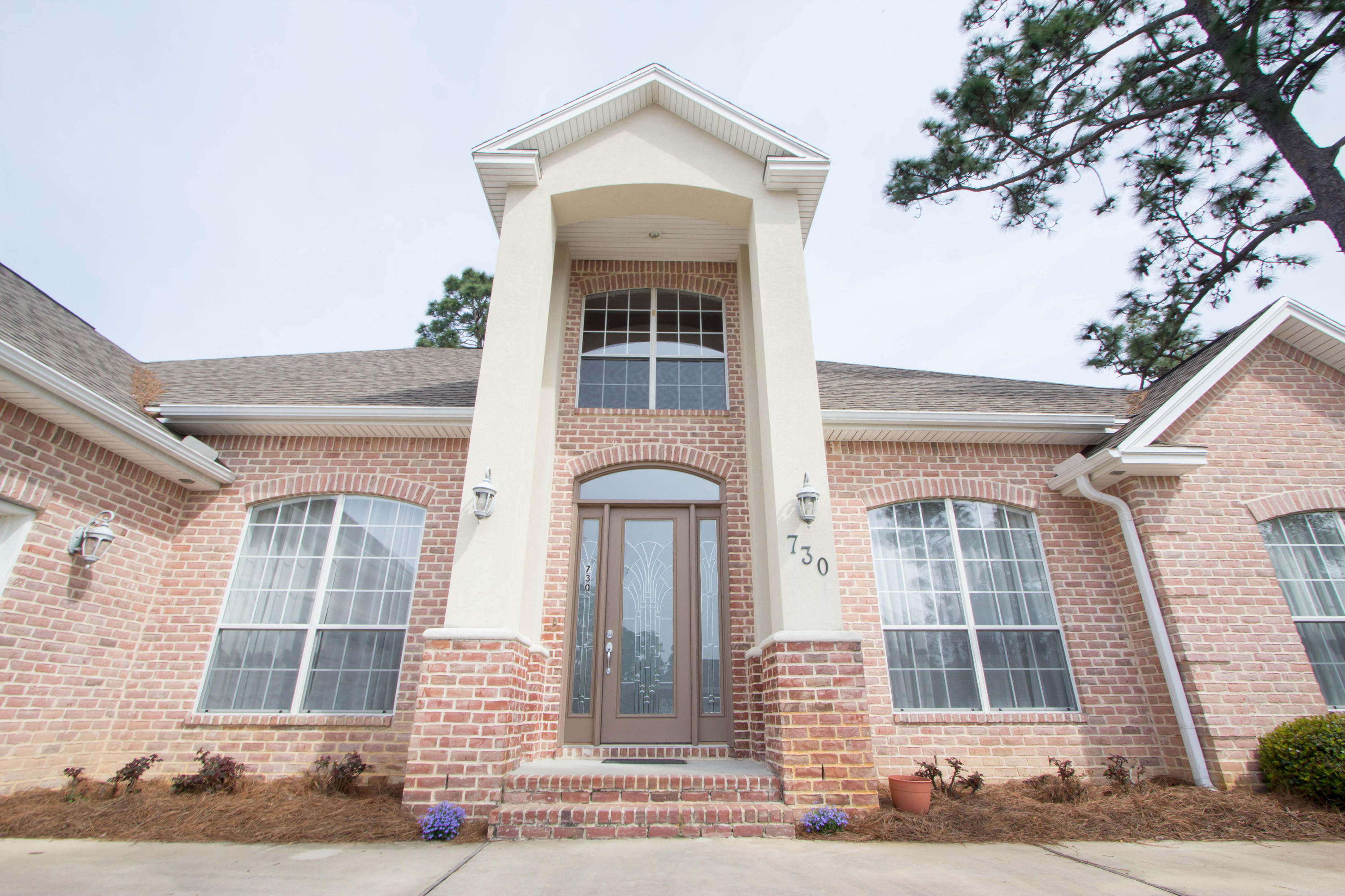 GOLD STAR PROPERTY! Contemporary Designed home available for the first time in Bayshore Place. The custom features begin with stunning stucco columns that lead to a beautiful lead glass door with side lights and transom window for lots of natural light. You will want to call this home from the moment you walk through the door with the high ceilings, crown molding & elegant wood floors in all living areas. Off the foyer is two speculator rooms. A office or living room is to the right with 8 ft. French Doors to grace the entrance along with arch windows. The dining room is to the left with a trey ceiling, chair rail, & beautiful chandelier. The family room is the center of the home.