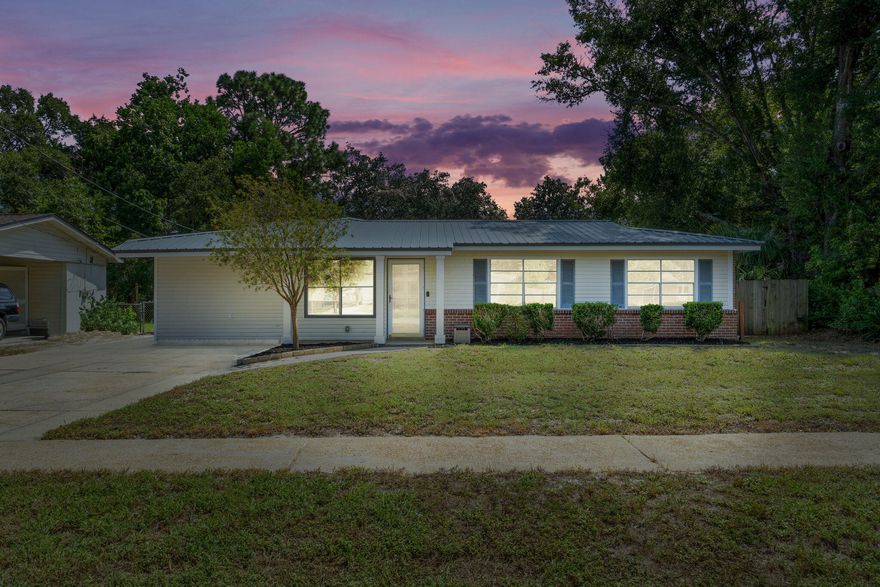 When you step inside this three-bedroom, two-bathroom home, you'll be greeted by a spacious open floor plan. Engineered wood flooring throughout the main areas creates a cohesive look through the entire living area.The kitchen is updated with newer cabinets with soft-close drawers, black hardware, marble-look counters, and KitchenAid stainless appliances. The primary bedroom has an exterior door, making it ideal for the owner, a roommate, or a guest to have privacy as they come and go. The bathroom has a modern single vanity, soft close drawers/doors, and a tub/shower combo. The split-bedroom floorplan offers two additional bedrooms located at the end of the main hallway, adjoined by a unique jack-and-jill bathroom.