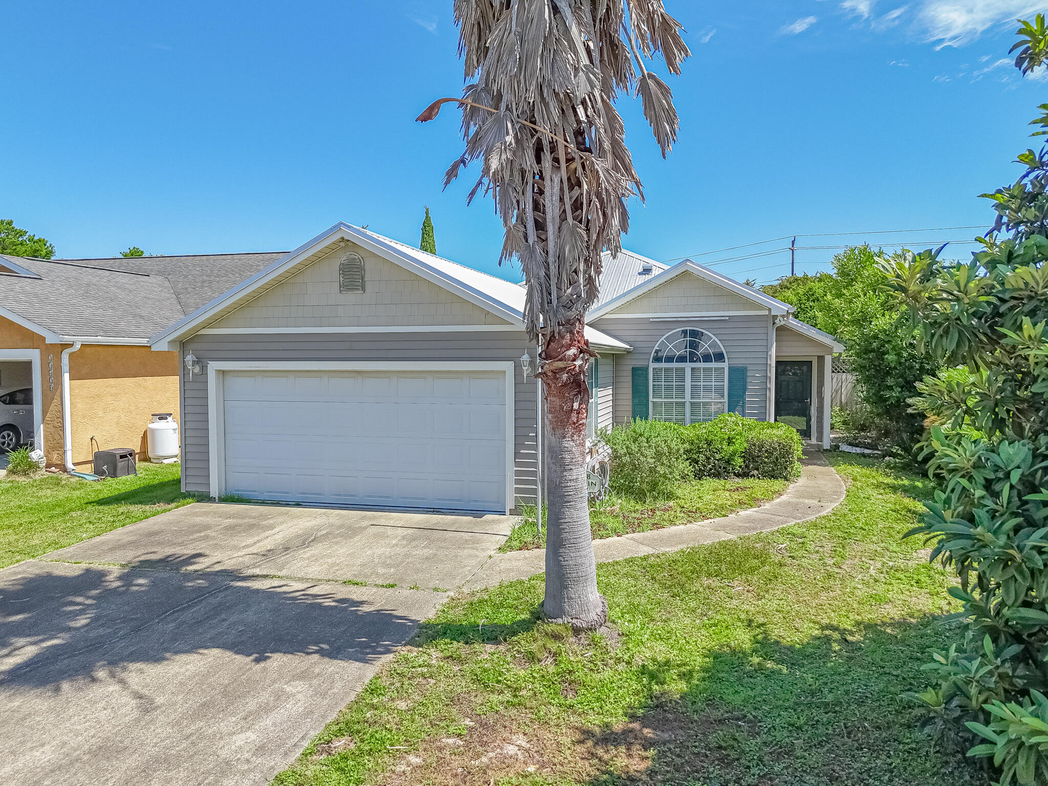 Coastal Charm & Prime Location - Just 5 Blocks from the Beach! Welcome to this Riviera Beach home, a cheerful 3 bedroom 2 bath home offering 1,344 square feet, built in 2003 and nestled in this PCB west-end neighborhood. This beach-side gem is just a short stroll to the Gulf, and offers a bright, open layout with vaulted ceilings, natural light, and tile & carport throughout. The kitchen features stainless steel appliances, plenty of cabinet space and a passthrough bar into the living area - perfect for casual gatherings or entertaining. The home includes a split-bedroom floor plan, spacious screened-in patio, two full bathrooms and a laundry room. Located just minutes from Pier Park, Frank Brown Park, 30A, and convenient to local schools, shopping, and PCB events, this home is ideal as a primary residence, second home or vacation rental. With NO HOA and strong short-term rental potential, this property delivers excellent value and flexibility. Schedule your private showing today- beach living is calling! If measurements deemed important, please verify.