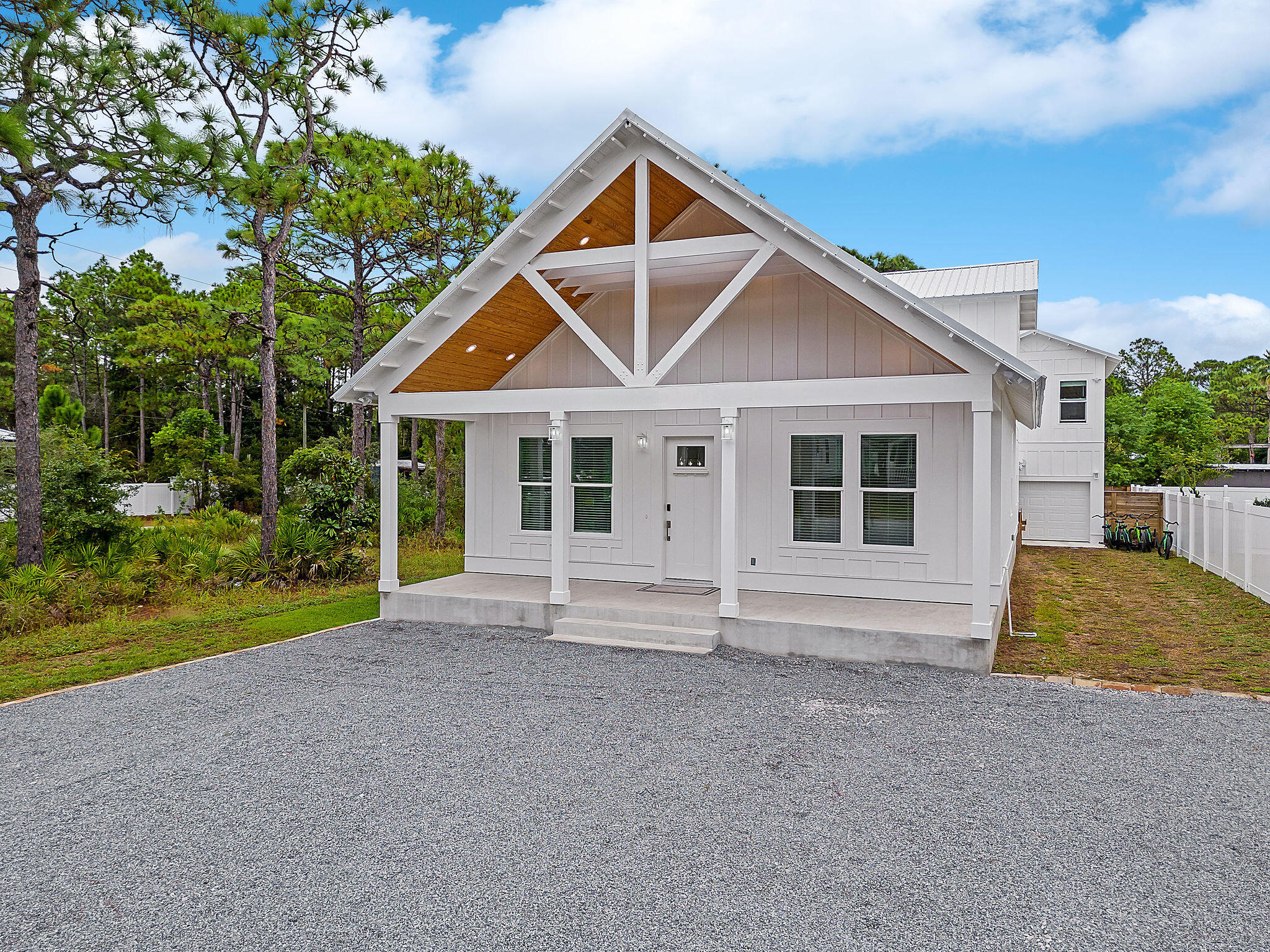 Built in 2022, this modern Gulf Shore Manor home is a beacon of contemporary luxury. With modern decor and furnishings, it offers a fresh take on coastal living. Nestled in a non-HOA community, this property presents a golden investment opportunity. Situated just half a mile from the Gulf and the San Juan Beach access, it is a prime spot for short-term rentals. Enjoy the ultimate relaxation with your own private pool and hot tub, complemented by outdoor entertaining space. Natural light floods every room, creating an inviting ambiance. The home has 5 bedrooms and 4.5 bathrooms catering to both accessibility and comfort. There is an additional bonus room upstairs with flexible space for a game room, media room or additional bedroom conversion. A carriage house with a kitchenette adds