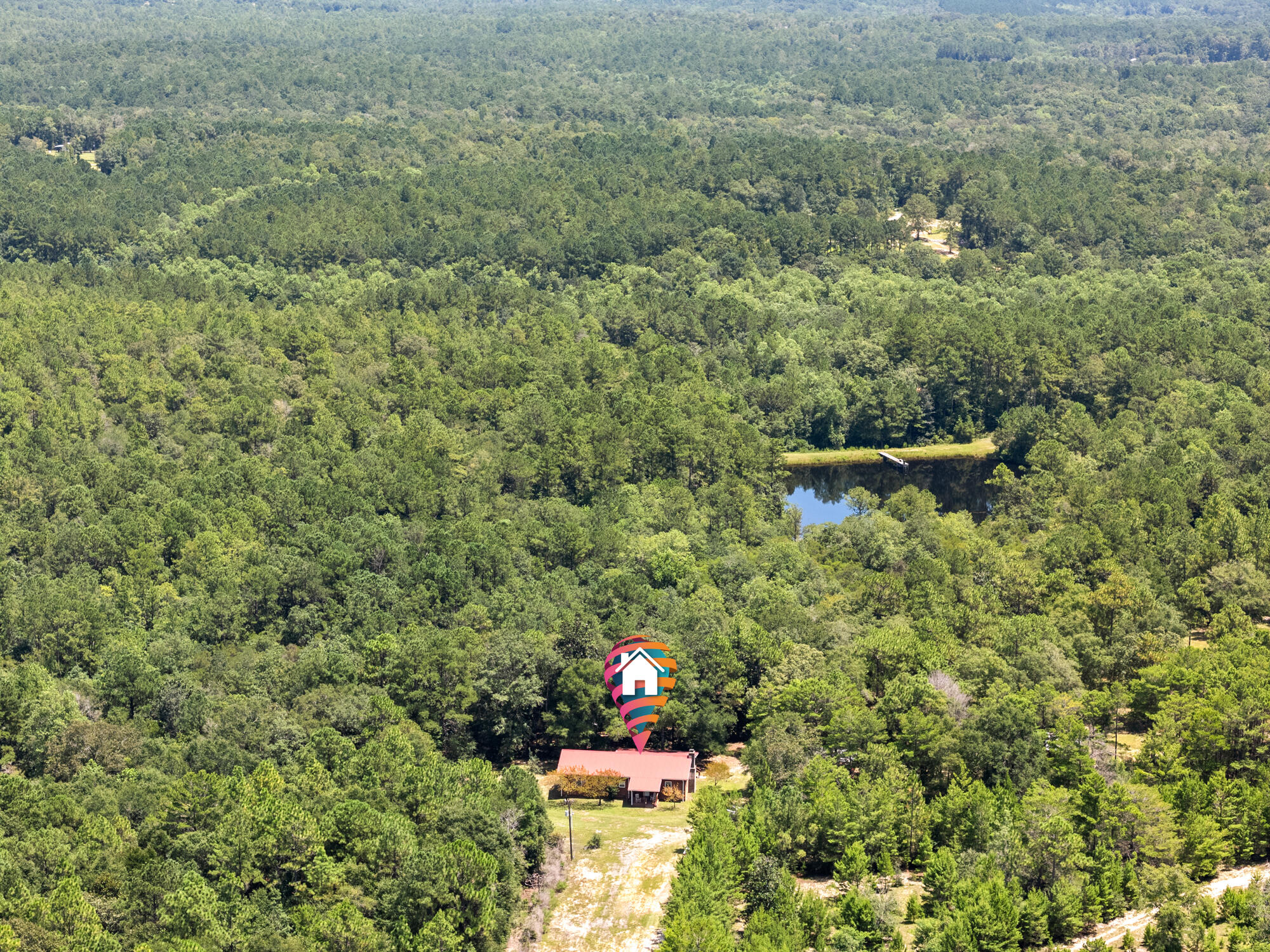 50 Wooded Acres with Cabin, Lake & Barns! Discover your own private retreat on 50 wooded acres featuring a 1,920 SF cabin-style home with a stunning custom stone fireplace. Two rustic one-room cabins with generator power add charm and flexibility. A 1,000 SF barn comes with tractor, attachments, and zero-turn mower. Horse lovers will appreciate the 2-stall barn with tack room, hay loft, and 3+/- acre fenced pasture. Trails weave throughout the property for horseback riding, nature walks, or four-wheeling. At the center lies a picturesque 3-acre stocked lake with bass, bream, and catfish. Lovingly developed, this property offers endless opportunities for recreation and relaxation. Property holds an abundance of deer & turkey! Shown by appointment, 24-hour notice required.