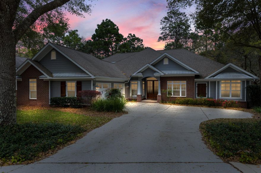 This stunning home in the desirable Swift Creek Subdivision is ready to welcome you!  You are greeted with beautiful double wood front doors that lead you into the home that has crown molding and custom trim work throughout.  This home takes advantage of the wooded backyard views through all the oversized windows.  It has a gorgeous kitchen with a gas stove, custom kitchen island, walk in pantry, farmhouse sink, new 2020 stainless appliances, 2020 Kitchen Aid fridge, under cabinet lighting and beautiful brick accent.  There is a dry bar/coffee bar area and built in plate rack.  Off the breakfast area is a concrete outdoor grilling porch that has a gas hookup.  The family room has beautiful coffered ceilings,