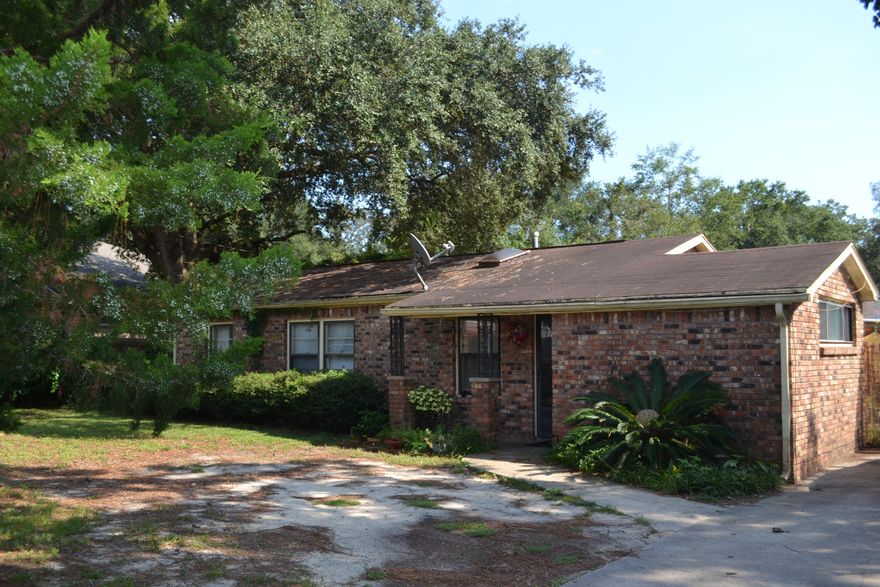 Huge Lot and great potential with this 4 bedroom home! Kitchen overlooks the extremely large family room that features a wood burning fireplace.  Lots of great space in this home.  New water heater installed . Washer and dry can convey if noted.  This home is being sold in it's current condition with no repairs.  This would make an amazing investment property. Survey available.