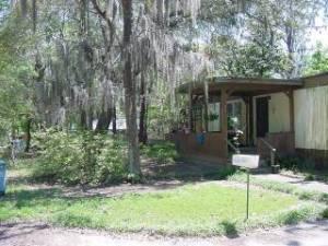 This huge lot is almost 1/2 acre and has 2 septic tanks on the property. Therefore, it has many possibilities. It has a mobile home on the site 80X14 with a 16X19 family room addition with a fireplace, a 12x16 outside shed, a plant potting shed and a detached carport.GREAT POSSIBILITIES!