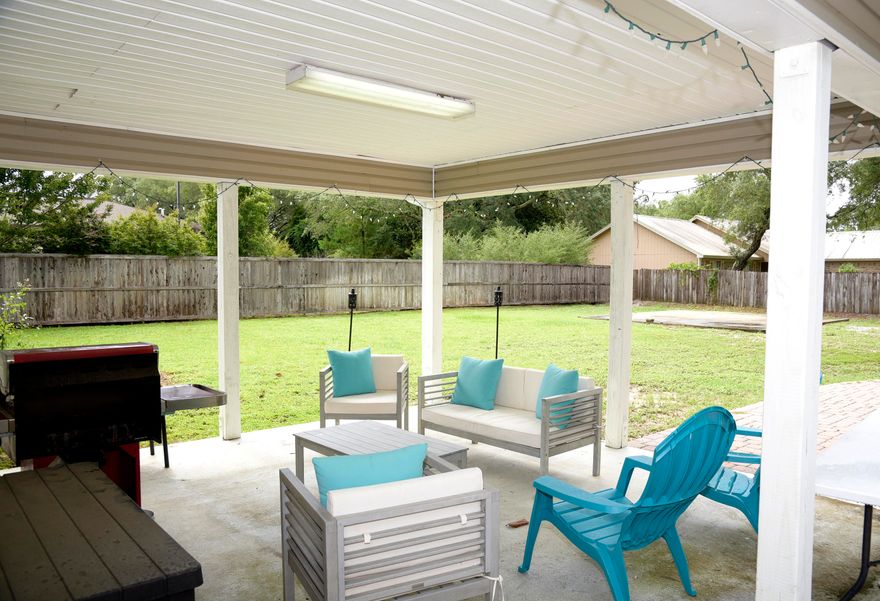 This lovely 2000 sq. ft. 4 bedroom 2 full bath home home has had a number of upgrades and is ready for you to settle in and enjoy life on the Emerald Coast. The kitchen features granite countertops, breakfast bar, stainless steel appliances and a farmhouse sink! There are beautiful hardwood floors in many rooms as well as updated lighting, ceiling fans and mirrors. The vaulted ceiling in the living area gives a spacious feel and the many windows make it bright and cheery. On .36 of an acre, the lot is large and able to accomodate anything you might think of! A second garage or workshop? There is already a large cement pad poured just for that reason and there is still room for a pool! Park your boat or RV there and enjoy the high privacy fence that makes you feel like you are in the country while being in the city! An open paver patio and covered back patio make it easy to enjoy the backyard. New roof in 2017 and HVAC in 2020-what more could you want? This is a rare find for Niceville.