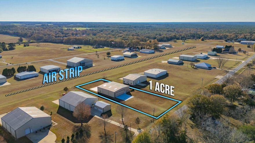 - Private aircraft hangar with integrated living space on a 1 acre lot.- Hangar features two high-clearance bi-fold doors, polished concrete floors, and ample storage space for aircraft or large equipment.- Comfortable living area includes:Modern kitchen with stainless steel appliances and granite countertops.Spacious bedroom and full bath with walk-in shower.- Murphy Bed in living quarters- Open layout combines functionality and convenience.- Large lot offers easy taxiing and additional parking.- Mezzanine area above living quarters for even more storage!- Ideal for aviation enthusiasts or those needing a versatile live-work space.- Property comes with ownership stake in the on-property fueling station saving you money on fuel!-- Schedule a showing today!