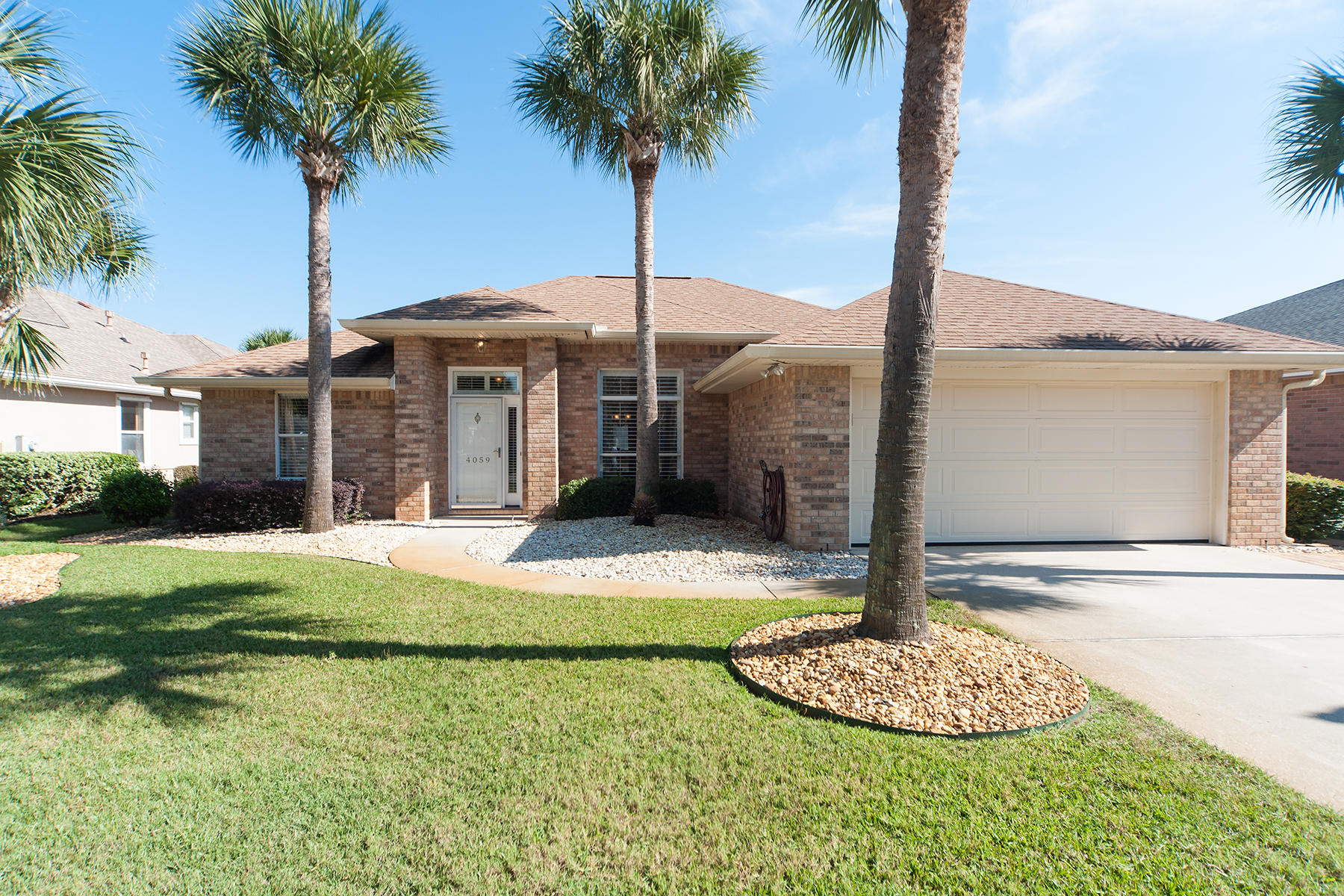 Located in the heart of Destin, this beautifully updated home in the highly sought after neighborhood of Indian Lakes is sure to please. Upon entering the home through the foyer, you are greeted with the open floor plan and ease of living. The Florida Room lets onto the sparking pool with screened enclosure. Enjoy warm afternoons soaking up the sun or taking a dip in your private pool. The updated eat in kitchen with pantry overlooks the pool and features new granite counter tops, tile back splash, cabinetry with ample storage and is open to the living room for easy entertaining. The spacious living room with vaulted ceiling features a corner gas fireplace. The relaxing split Master Bedroom Suite with tray ceilings overlooks the pool and enjoys a large walk in closet.