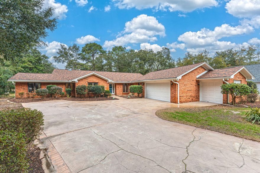Don't miss the new 360 Tour! 603 W Birkdale Circle is the quintessential Bluewater Bay home, situated on a spacious 0.41 acre lot dotted with mature Oaks and backing to the 8th fairway of the Bay Course. This updated, single-level brick home delivers charm, function, and comfort as well as a serene setting in the heart of a desirable resort community. Inside, discover captivating architectural details like soaring cathedral ceilings, banks of casement windows, and thoughtful built-in cabinetry in nearly every room. To the left of the foyer, find three ample sized bedrooms all with NEW carpet and two beautifully updated bathrooms.  Straight ahead and to the right side of the foyer lie the great room, flex room, sunroom, updated eat-in kitchen, laundry, half bath, and oversized garage. With nearly 2500 square feet of heated and cooled living space, each room is perfectly proportioned to maximize flexibility, utility, and enjoyment. Not to be overlooked, the backyard offers abundant space for recreation and relaxation. Dine alfresco under the pergola located just through the sliding glass doors off the kitchen. Play catch or fetch on the expansive lawn bordered by mature landscaping and relish the open space provided by the fairway beyond. Park two cars PLUS a golf cart, set up a hobby/work bench, AND store holiday decorations in the huge courtyard entry garage! Recent updates: Carpet in all bedrooms (2025), water heater in garage (2025), paint in main living spaces and front bedroom (2025), wall added to separate great room from front flex room (2024), new stainless steel kitchen appliances (2024), paver patio extension (2024), roof (2020), primary bathroom (2019), kitchen (2014). Take full advantage of all that Bluewater Bay resort has to offer including golf, tennis, pickleball, pools (separate fees/memberships available for all these amenities), miles of recreational trails, a marina complex and boat ramp, restaurants, shopping, health care, and more are all within easy reach. Plus - NO HOA! Zoned for Bluewater Elementary School, with a choice of Destin or Ruckel Middle School, and Niceville High School. Jump on the Mid Bay Bridge quickly and easily to enjoy the Emerald Coast's world famous white sand beaches, entertainment, shopping, and more in Destin and South Walton. 