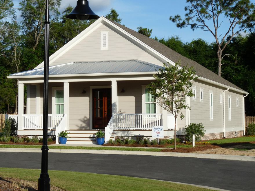 First Place Parade of Homes Winner! This new home takes advantage of indoor & outdoor living. Enter through the mahogany front door into the main living space connected to the kitchen.Vintage nailed-down walnut floors lead you to a side deck.Lots of natural light,subway tile backsplash, quartz counters and a stainless steel farm sink in the island deck out the large kitchen.Lots of storage down the hallway as you pass the wine fridge in the wet bar. Laundry room, two bedrooms, and a master bed and bath with access to the back porch round out this home. The master bath boasts a large walk-in shower, two vanities and walk-in closet system. Plantation shutters, temp sensor system,& painted garage floor are some of the extras in this cottage home.Impact glass windows, 2x6 exterior walls.