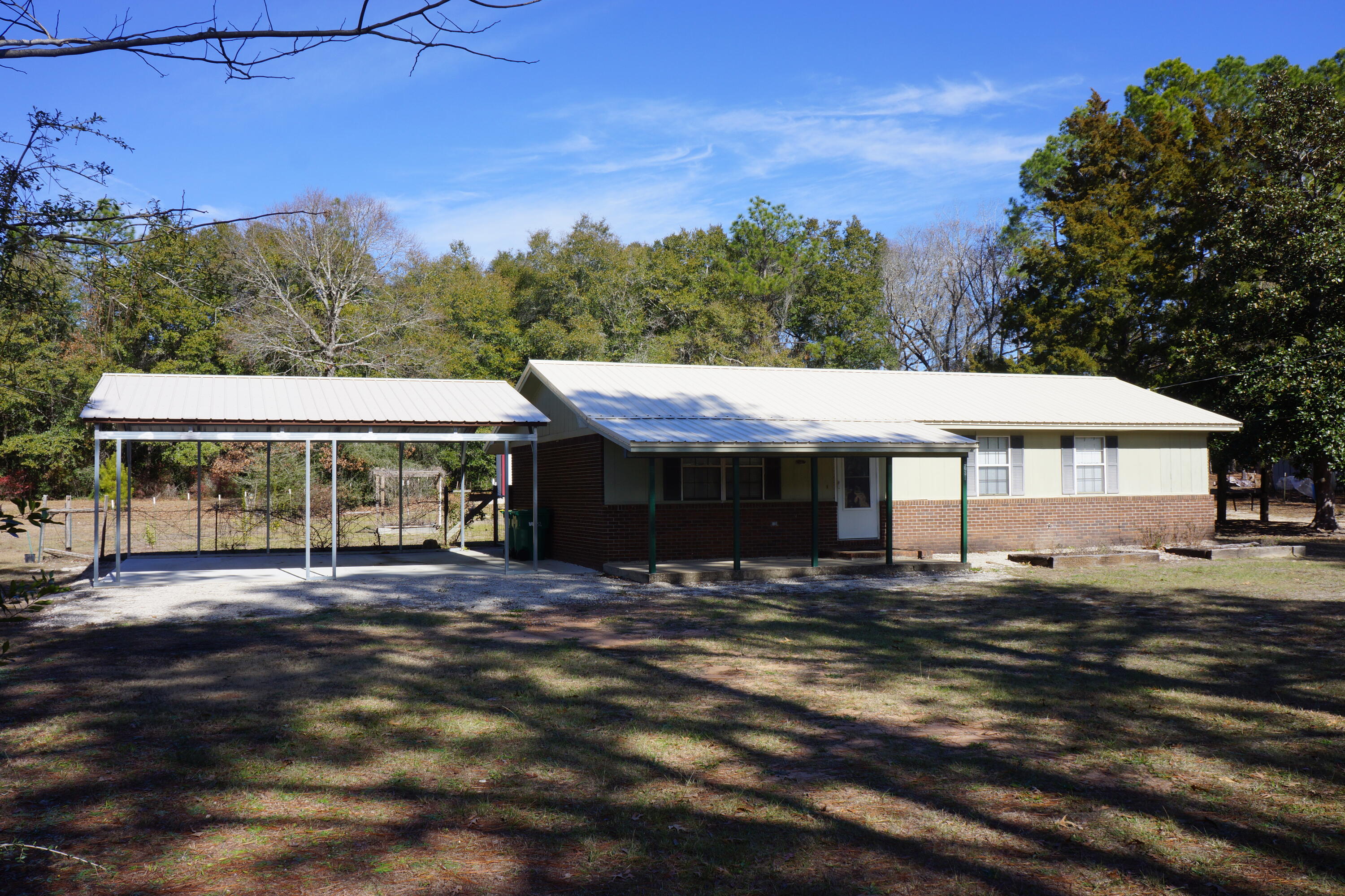 WOW! Here is your opportunity to own this great 1 acre property in Crestview. You'll have a brick 3 bedroom 1.5 bath home with new metal roof and 2car carport in 2023. New carpet in living room and bedrooms, wood laminate in kitchen and bath. Kitchen has double sink, smooth-top stove, microwave, dishwasher and refrigerator. A 2021 mobile home with 2 bedrooms 2 baths, kitchen has double sink, electric stove, range hood, dishwasher and pantry/laundry room. With it's own septic system and electric meter; use as a guest house or rental property. To top it off there is a great 30x66 steel building (30x40 workshop and a 30x26 carport). The workshop is fully insulated, has 2 walk-in doors, a 12x12 rollup door, LED lighting, and electrical receptacles every 6 Ft. LED and motion light on carport.