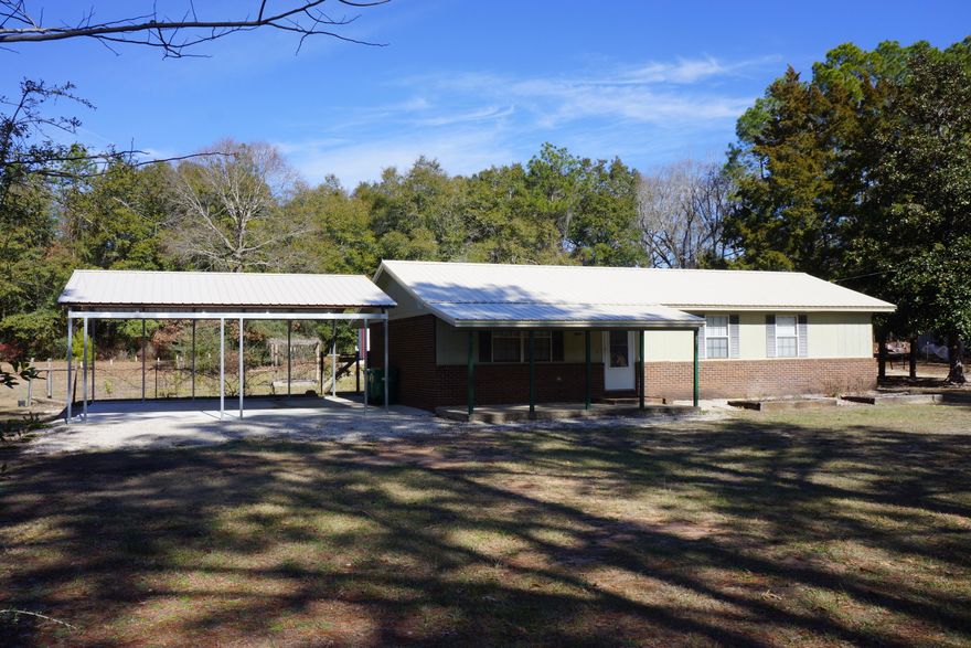 WOW! Here is your opportunity to own this great 1 acre property in Crestview. You'll have a brick 3 bedroom 1.5 bath home with new metal roof and 2car carport in 2023. New carpet in living room and bedrooms, wood laminate in kitchen and bath. Kitchen has double sink, smooth-top stove, microwave, dishwasher and refrigerator.  A 2021 mobile home with 2 bedrooms 2 baths, kitchen has double sink, electric stove, range hood, dishwasher and pantry/laundry room. With it's own septic system and electric meter; use as a guest house or rental property. To top it off there is a great 30x66 steel building (30x40 workshop and a 30x26 carport). The workshop is fully insulated, has 2 walk-in doors, a 12x12 rollup door, LED lighting, and electrical receptacles every 6 Ft. LED and motion light on carport.