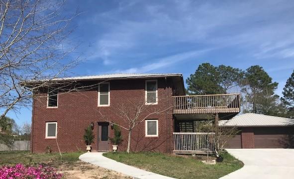 SPACIOUS home on 1/2 ACRE LOT with 3.644 sq ft 3 bedrooms 2 full baths & 1 half bath..ENERGY EFFICIENT, close to beautiful Navarre BEACH, a DETACHED 3-Car Garage with full Bathroom & kitchenette. Built Strong, walls 12'' thick, TRIPLE PANE WINDOWS. FEATURES an Open Floorplan, Stained Shiplap Accent Wall, TANKLESS Water System, METAL ROOF, lots of CLOSETS, ALL kitchen appliances convey as well as Murphy's Bed on 2nd LEVEL. ICF construction (INSULATED CONCRETE FORM) found to be tornado & hurricane resistant which is based on how the wall of the home is constructed. **13 MONTH HOME WARRANTY