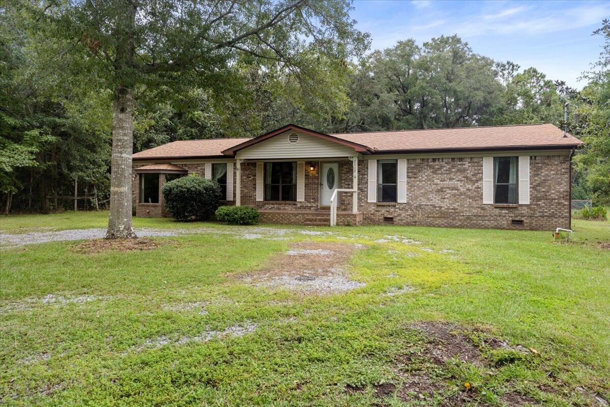 *MOTIVATED SELLERS, BRING ALL OFFERS* Welcome to this charming ranch-style country residence, featuring 1,945 sq. ft. of inviting living space on a generous 1/2 acre lot in a peaceful East Bay neighborhood. This all-brick home offers 3 bedrooms and 2 bathrooms, enveloped by the stunning natural landscape of Native Live Oaks and Magnolia Trees, creating a tranquil sanctuary. Enjoy the freedom of an unrestricted community with no HOA fees, conveniently located just across the street from East Bay. Enjoy a variety of outdoor activities, including exceptional fishing, horseback riding, and nearby stables, with a boat ramp situated less than a mile away, perfect for immersing yourself in the Florida lifestyle with friends and family. The spacious living area and formal dining room feature beautiful hardwood flooring an a seamless open-concept design, ideal for gatherings. On cooler evenings, unwind by the cozy wood-burning fireplace and savor the abundant natural light that fills the room through the skylight. This property is competitively priced for a swift sale and offers glimpses of the bay, making it a fantastic opportunity to join this vibrant community. This home is located only 14 min from some of the most beautiful beaches. Call for a showing today!