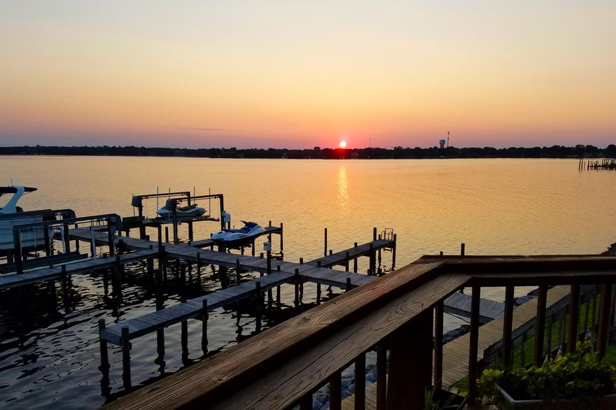 THE place for beautiful sunsets for years to come! This delightful townhome puts you just steps from your boat. Unit comes with a slip and boat lift. Two large custom decks and pretty landscaping. Generous Master Suite with garden tub. Additional kitchenette on first floor. Third bedroom could be used for an office area. You'll fall in love with the peaceful views of Garnier's Bayou! Don't pass up the chance for waterfront living at a budget friendly price! Please note: Only Small dogs and cats are allowable.