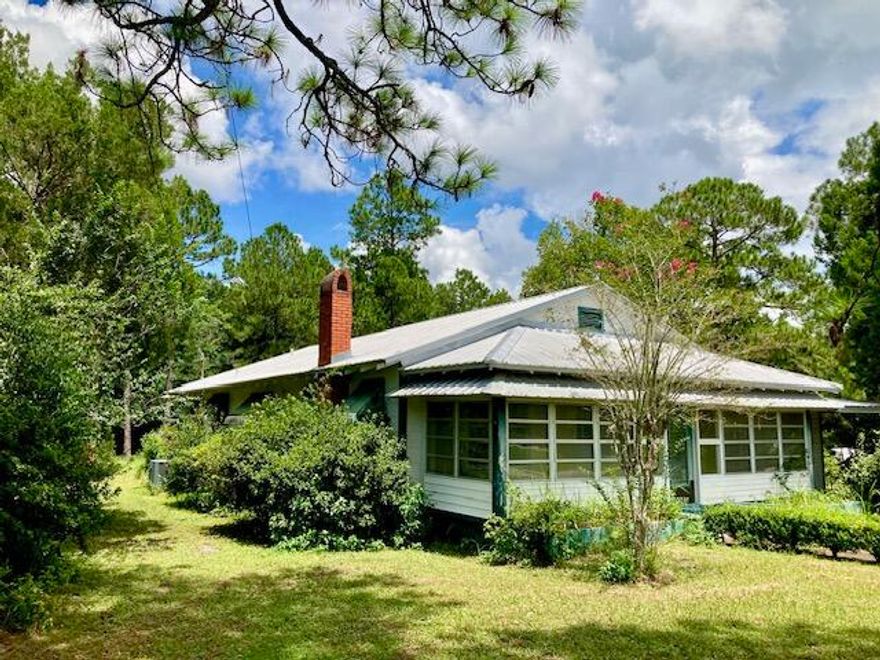 THE POSSIBILITIES ARE ENDLESS!! This 3 BR 1 BA house faces Hwy 90W in DeFuniak Springs and sits on a large lot (1.12 acre).  A metal roof, hardwood floors, central heat & air, plus FOUR enclosed porches and lots of extra lot space offer unlimited potential for this older property located in C-1 zoning.  Low impact uses for this property include residential, retail, office space or possibly a home-based daycare center..(Some improvements may be needed with the highway frontage depending on intended use).  While the house needs some updating,, it certainly could be lived in while renovations are made.  (There is an uninstalled dishwasher, range, and newer kitchen cabinets located on one of the porches that could be used to update the kitchen). A cash sale would be best for this property.