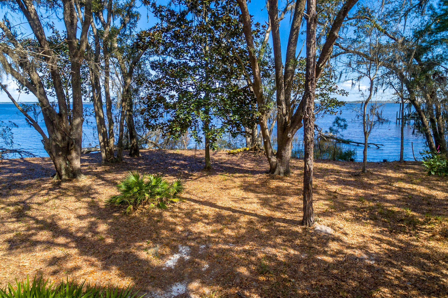 Double lot totaling .50 acres with 103 bayfront feet in popular Magnolia Beach in Point Washington. Just a stone's throw from Grayton, Watercolor and Seaside. Sweeping bay views with large oaks and magnolias, along a natural beach shoreline. Located at the end of a dead-end street for privacy. Recent survey & wetlands study available (see attached documents incl county setback requirements & dock permitting guidelines). Small pond on the property and yet still room to build with driveway already in place. Underground power and electric already in place. Approximate 5' drop to the water, perfect for adding a dock. Plus a gentle slope to the water on the east side, for the best of both worlds.