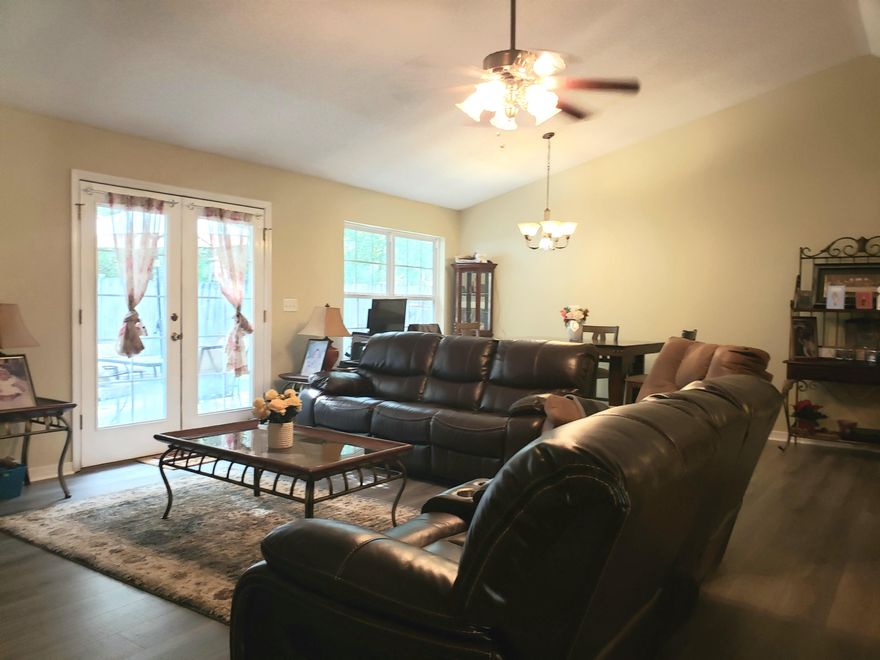 Custom built by Gamble Construction ! This well maintained cozy brick front house has an open kitchen, dining and living room concept with a large kitchen has plenty of cabinet and food prep space. New wood look  flooring throughout the hallways and living room, new paint, and a full adjustable screen enclosure for the garage / mancave.  Out back you will find a privacy fence and a storage shed that stays, and there is the  privacy of woods behind you. Centrally located and in a small quiet neighborhood.