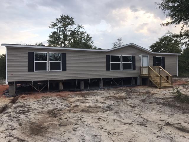 This a brand new manufactured home sitting on a 1/2 acre lot. Where can you find a brand new home on 1/2 acre lot for under $100,000? This home has an open spacious floor plan, walk in closets, and a separate utility room. Plenty of cabinets and a kitchen island. The property has a nice country setting. Close to Ft. Walton and Destin this is perfect for a family moving into the area. Several lenders offering easy online applications for financing. Gravel drive to be added.