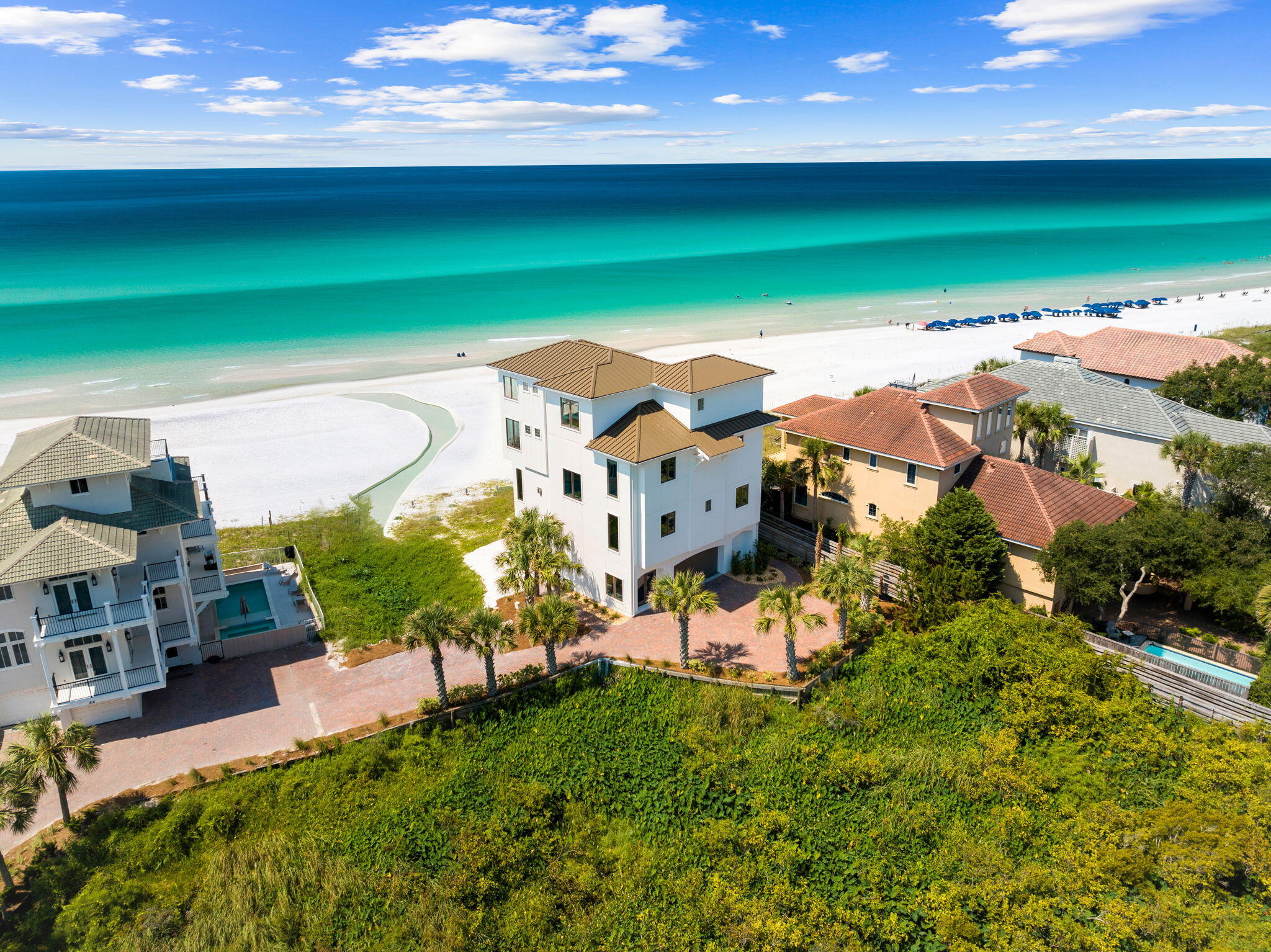 Prominently positioned on 70'+ of prime Gulf frontage, this newly transformed coastal masterpiece is located within a privately gated enclave on the coveted west end of 30A affording modern luxury with impeccable attention to detail juxtaposed timeless interior design. Situated on half an acre with exemplary privacy including buffered wetlands north of the property, this 4,756-square-foot home is an architectural marvel, offering 6 bedrooms and 6.5 baths and thoughtfully reimagined in 2024 embodying both strength and elegance with marine-grade finishes and robust materials designed to withstand the elements of coastal living. Upon entry, the expansive parking court welcomes you, leading to an oversized two-car garage with ample storage space as well as an elegant foyer entry with elevator access to each level of the home. The second floor opens to a grand living room, setting the stage for relaxed yet refined living including picture perfect window placement of floor to ceiling glass to capture endless views over the swoon-worthy emerald waters and crystal white sand of the Gulf of Mexico. Here, one of the six bedrooms awaits, ideal for guests or a private office. The second level is anchored by a beautiful chefs kitchen with custom cabinetry, stainless appliances and ample cooking space all of which enjoys natural lighting from northern and southern exposures as well as direct access to the second floor covered lanai that soaks in western and southern facing vistas with unobstructed views of the gulf from the private heated plunge pool.

Ascend to the third floor, where the primary bedroom becomes a sanctuary of serenity with its spa like en-suite bathroom enjoying pristine gulf vistas, complemented by a secondary bedroom and a versatile sitting roomideal for moments of quiet reflection or intimate gatherings. The fourth floor captivates with its dynamic layout, featuring another primary suite and a spacious bunk room, alongside an additional sitting room, designed for ultimate flexibility in hosting family and friends.

What truly distinguishes this home are its unobstructed western views, capturing the mesmerizing sunsets from every level, culminating in a panoramic experience on the top-floor viewing deck.

Every detail of this home has been meticulously crafted, from the new Senergy Sentry Ultra Stucco Wall System with enhanced water management to the Andersen A Series windows and doors that offer unparalleled durability and style. The exterior spaces are equally impressive, featuring new TREX decking and a beach staircase that seamlessly blends with the natural landscape, offering direct access to the pristine sands with over 4.2 acres of accessible beach just behind the home.

58 S Spooky Lane isn't just a home; it's a statement of coastal elegance, a fortress of comfort, and a canvas for unparalleled living, where every sunset marks another day in paradise.

Reach out to us today for cost to own figures and rental projections.