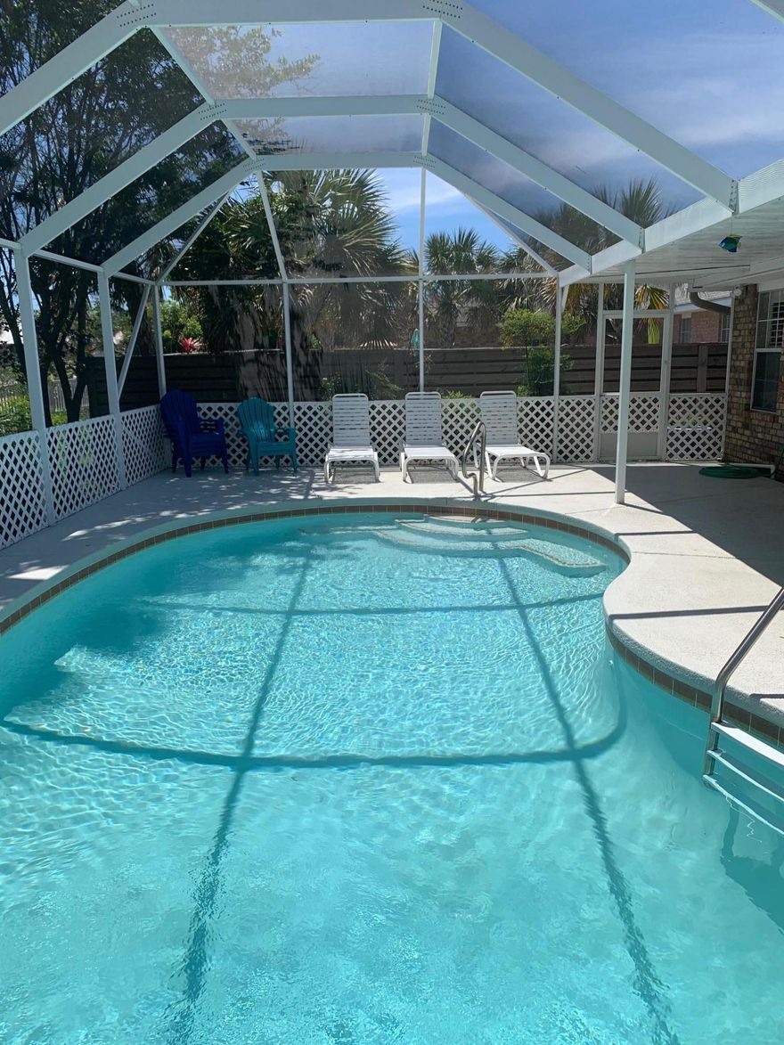 BACK ON THE MARKET! Open concept home with vaulted ceilings & 3 eating areas (Dining, breakfast nook,& breakfast bar)  Spacious master bedrm. w/walk in closet. Master bath w/double vanity & walk in shower. Upgrades include granite countertops in kitchen with large island, stainless steel appliances, tile throughout home, plantation shutters, & full size washer/dryer. Double car garage & long driveway 
This 4/2/2 home is situated on one of the largest lots in the beach side, gated community of Paradise Retreat. Having one of the largest heated private pools with screened in lanai,this home is a great rental! Summer already booked!  Paradise Retreat has its own private beach access to 320' of deeded beach; no huge crowds to endure! Come & enjoy Florida!