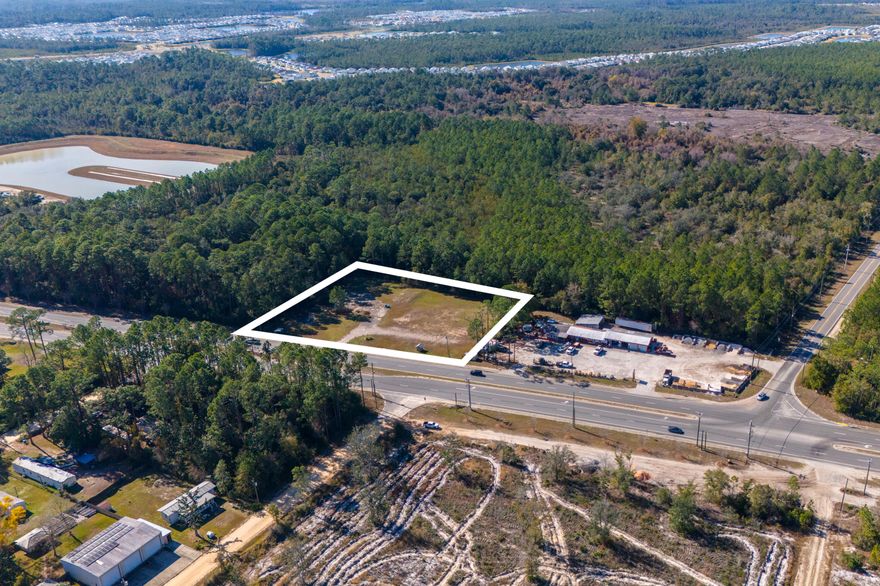 This is an excellent opportunity for future commercial development in Panama City Beach, Florida, less than a mile north of Latitude Margaritaville, a booming master-planned community by St. Joe, featuring 3,500 new construction homes as well as a Publix Super Market-anchored shopping center that has just broken ground.Two separate parcels are combined here (9909 & 9905), offering 1.78 acres of land and 335' of road frontage on Hwy 79, with AADT of 16,200.  The Northwest Florida Beaches International Airport, ranked the 4th fastest growing airport in the United States, is a little over 3 miles to the east.  The new Tallahassee Memorial Hospital complex is just 6 miles to the south, with the first building opened this past summer and a large campus planned over 87 acres.  This property  is zoned Village Center, which allows for a multitude of uses, including R-5 (Residential), C-1 (Neighborhood Commercial), C-2 (Plaza Commercial), C-4 (Research and Design), Public Institutional, Parks and Open Space, Civic use and others. Village Center zoning allows for 10 dwelling units per acre.  The current owners also applied for and received a CUP approval for operation of a WAREHOUSE FACILITY.   Buyer is encouraged to contact Bay County Planning and Zoning to verify all zoning information.  2 septic systems, 2 well houses, and 2 power poles exist on site, along with numerous RV hookups.  FDOT has already approved an entrance from 79 to property.  Soil borings and geotechnical reports have been completed for a warehouse and can convey.
The county currently allows for up to 8 mobile homes, which presents an opportunity to offset holding costs until further development.  Existing RV hookups and water connections are on site now, but RV park is not an allowable use.  This is the perfect opportunity to seize a commercial development opportunity in a booming area!
St. Joe is working with the county to develop an additional 1702 acres across the street, between this parcel and the airport.  That development is proposed to offer an additional 3,300 residential units and 450,000 sq ft of commercial space.  St. Joe is negotiating with county on how utilities will be run to their property, but that proposed development should be a great asset to this property.