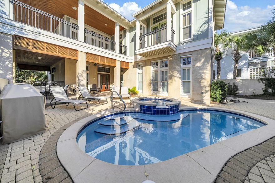 This is a sale of 1/3 interest in Nestled Inn At Seagrove Beach Llc which is the title holder of the property. Discover this exceptional three-story beach home on Kristi Lane in the heart of Seagrove Beach. Located just one row from the sugar-white sands of Scenic 30A, this one-of-a-kind five-bedroom retreat blends coastal luxury with thoughtful design, featuring an open, split floor plan and highly sought-after primary suites on both the first and second levels.The welcoming front porch opens through double doors into a light-filled great room with soaring ceilings, classic wainscoting, and abundant windows with transom accents. The dining area comfortably seats eight and flows seamlessly into the kitchen, complete with a large breakfast bar island, cabinetry, KitchenAid stainless appliances an a vented hood, granite countertops, natural wood cabinetry, and a custom pantry.
Just off the main living space, the laundry and drop zone offer convenience after a day at the beach, featuring an LG washer and dryer, KitchenAid ice maker, and an attached full bath. Step outside through double doors to your private backyard oasis, where a covered patio, expansive brick-paver pool deck, pool and sitting spa, and outdoor kitchen create the ultimate setting for Florida outdoor living. A pool alarm provides added peace of mind.
The first-floor primary suite is filled with natural light and offers a spacious walk-in closet, dual vanities, and a separate shower. Upstairs, the second level hosts a comfortable living area with wainscoting, a large sectional, wet bar with mini-fridge, and an expansive wraparound covered porchideal for entertaining or relaxing coastal evenings. Two generous guest bedrooms are also located on this level, one with an en-suite bath, along with an additional primary suite with a spa-like bath with garden tub, dual vanities, a dual-head tile shower, and a private Juliet balcony overlooking the pool deck.
The third level offers a private guest suite with an en-suite bath and access to its own balcony. Additional highlights include deeded private beach access, an outdoor shower, ample parking with an expansive brick-paver driveway and covered spaces, and lush landscaping featuring Southern magnolias and Florida palms that create a warm coastal welcome.
This Seagrove Beach home captures the essence of the 30A lifestylesteps from the sand, thoughtfully designed for gathering, and perfect for relaxed coastal living.