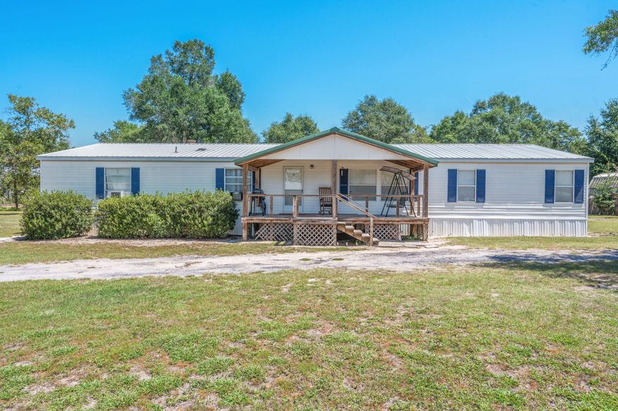 Welcome to this inviting 4 bd, 3 ba home offering 2,280 sqft of comfortable living on just under 1 acre, already split into two separate lots for flexibility or future investment. The home features two spacious living areas, perfect for family gatherings or quiet relaxation. Theres a huge updated back deck for easy outdoor enjoyment. The dining area & a kitchen with a pantry (all appliances stay) make daily life a breeze. The split floor plan offers 3 bd & 2 ba on one side & a private master suite with built-ins, walk in closet, soaking tub, and double vanity on the other. Additional highlights include updated  HVAC metal roof, updated well, updated laundry flooring, shed with electricity, & neatly lined bushes for  appeal. Perfect for multi generational living or a separate living area.