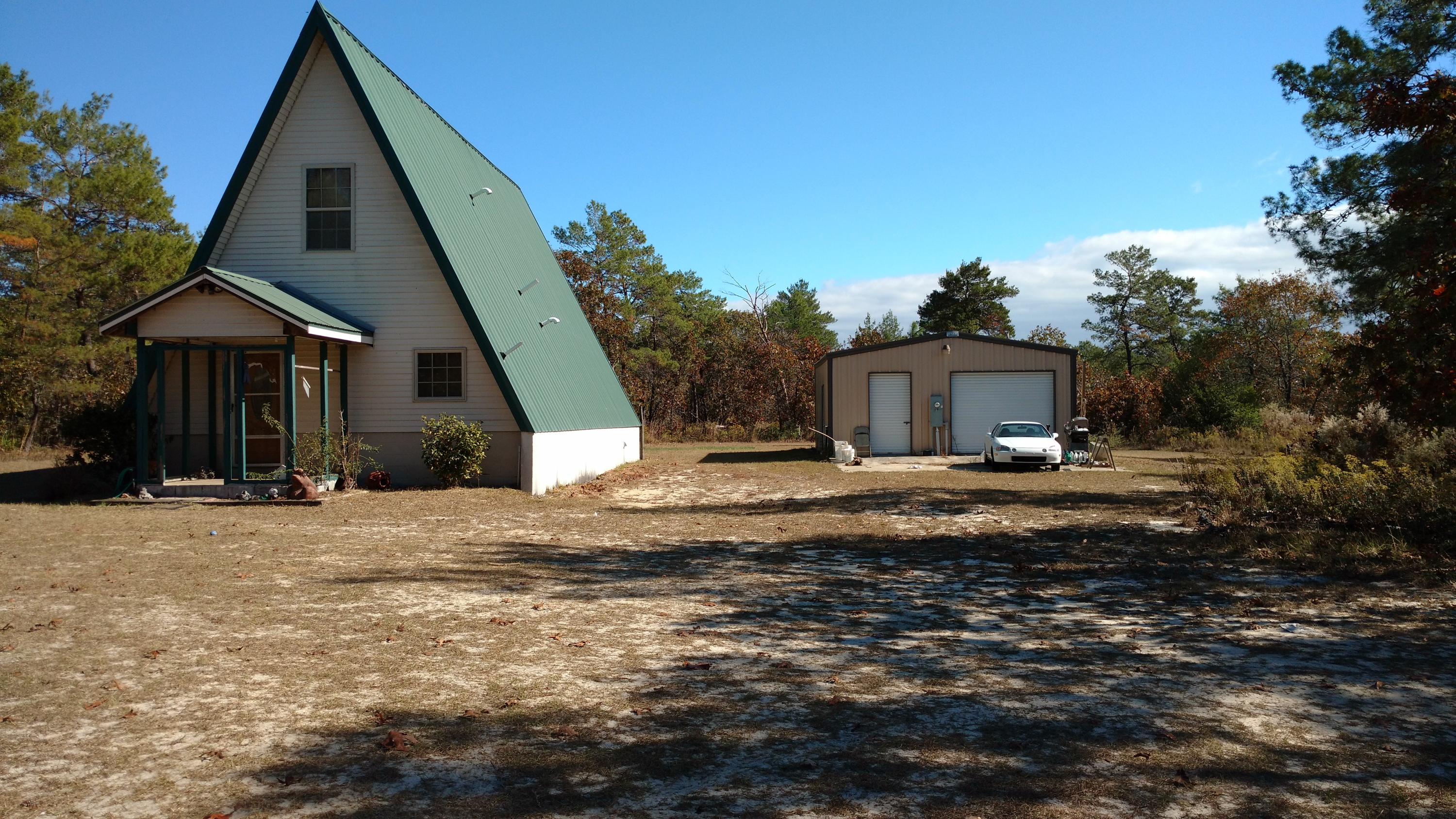 Looking for that acreage with a nice home and nice work garage, this is the place. Quiet neighborhood, 4.68 acres, with a nice A Frame home. Half of the property has been cleared and the other half is wooded. Needs a little work, but home is a steel home, and very sturdy. Great possibly for the property.